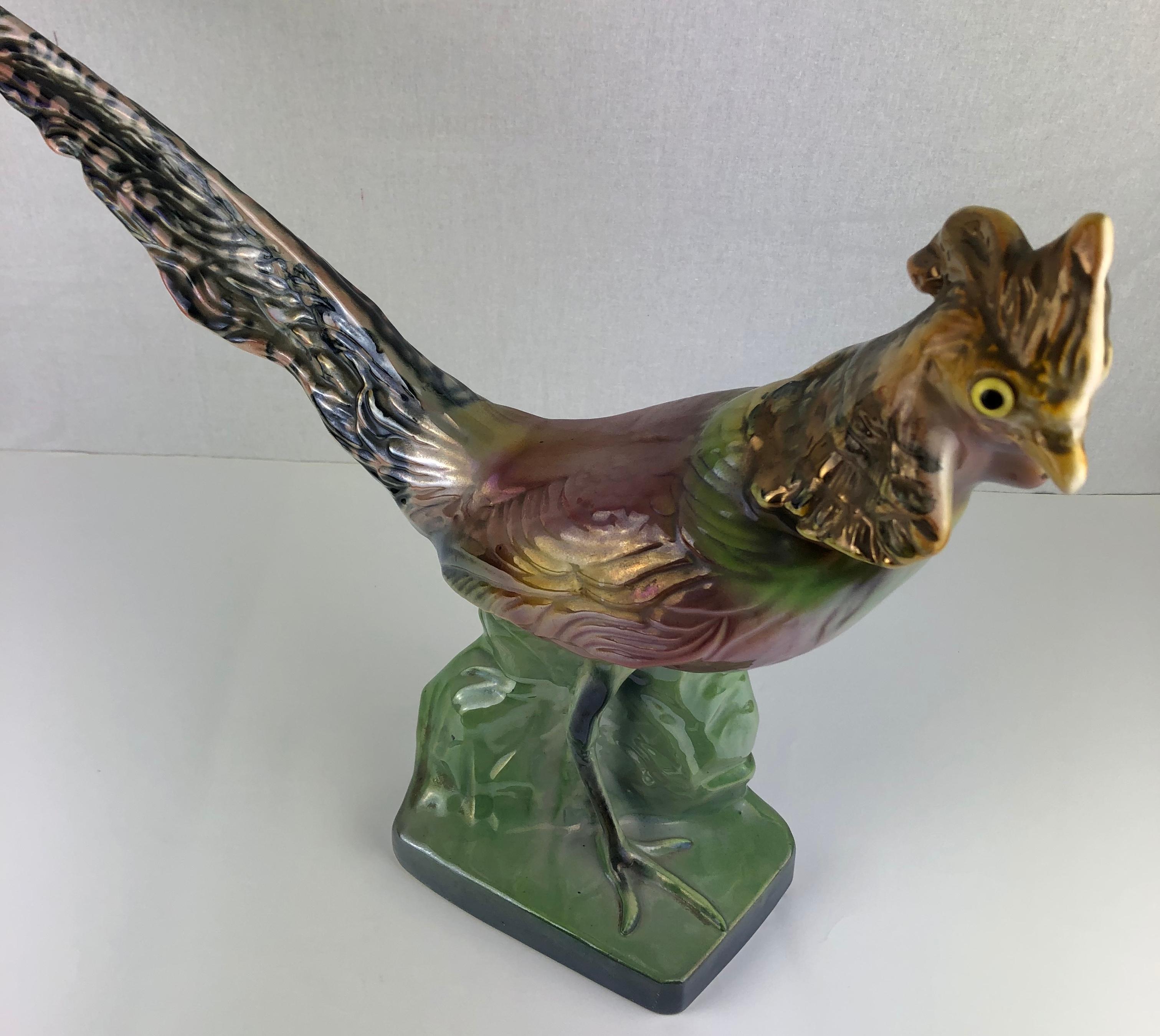 Sculpted and hand painted pheasant figure with stunning colors and details. 

H. Bequet began creating beautiful ceramics in 1926 at the Belgian ceramics manufacturer Auguste Mouzin et Cie (AMC). Bequet opened his own ceramics production factory