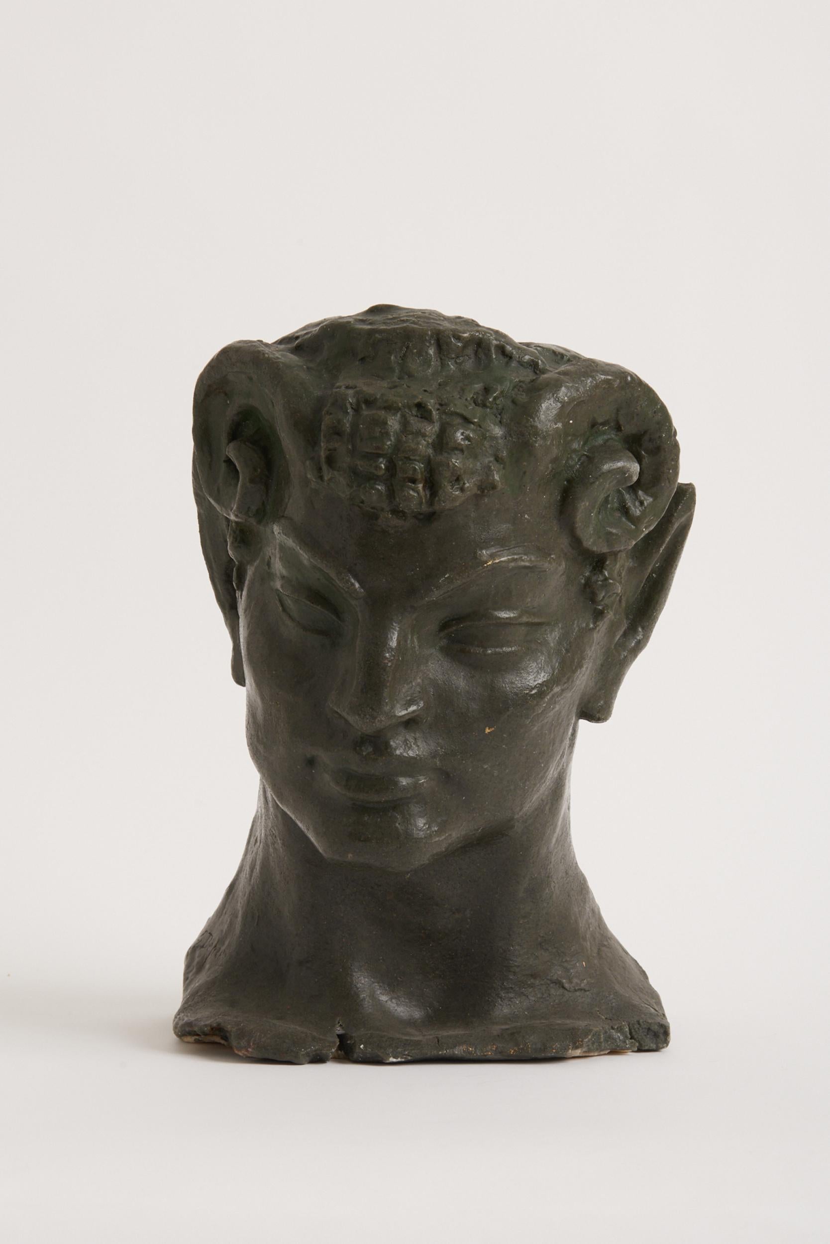 A carved wax sculpture of a faun's head.
France, early 20th Century.