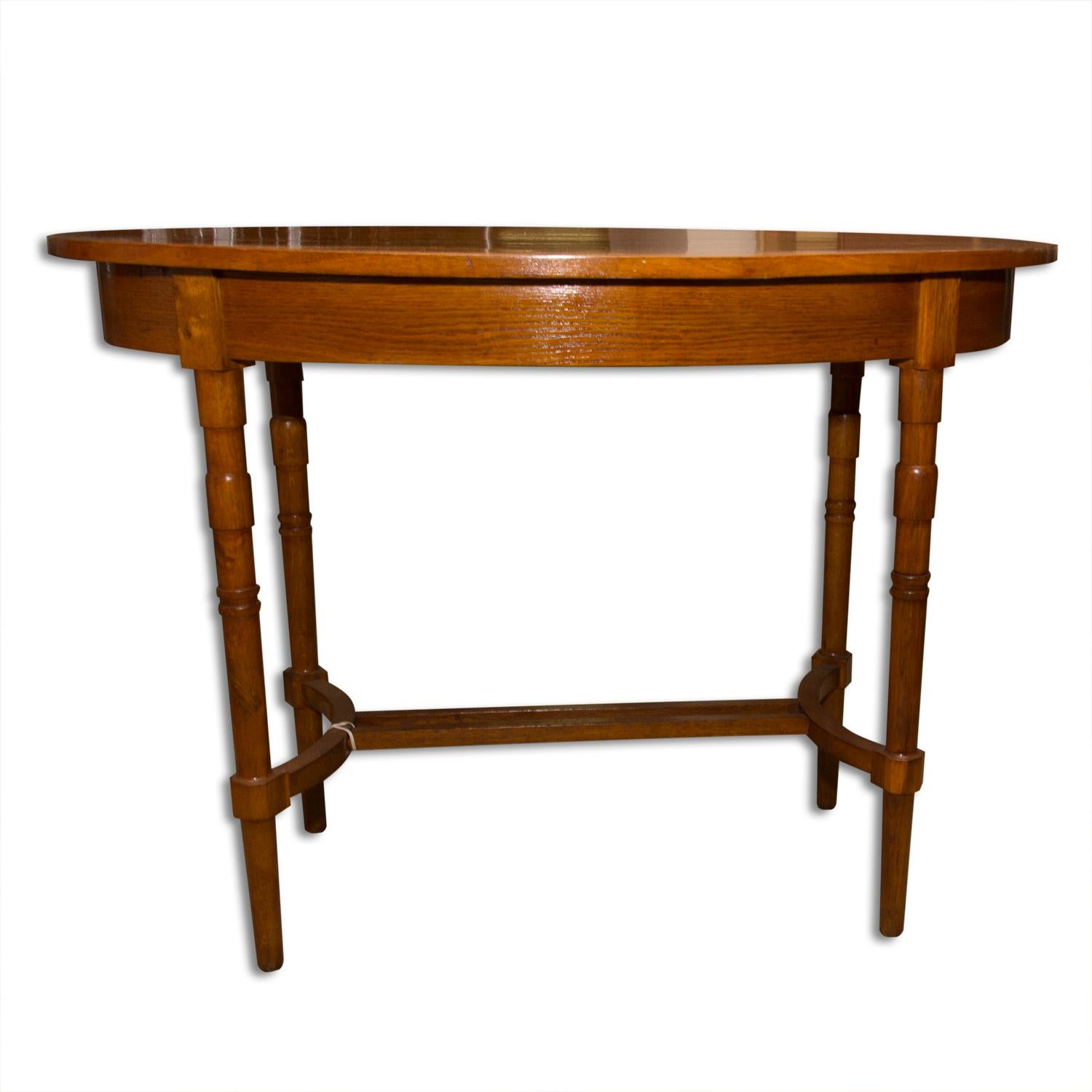 This oval occasional table was designed and produced in Austria-Hungary, circa 1915. It was made of oakwood. The table is completely refurbished and varnished to a high gloss.