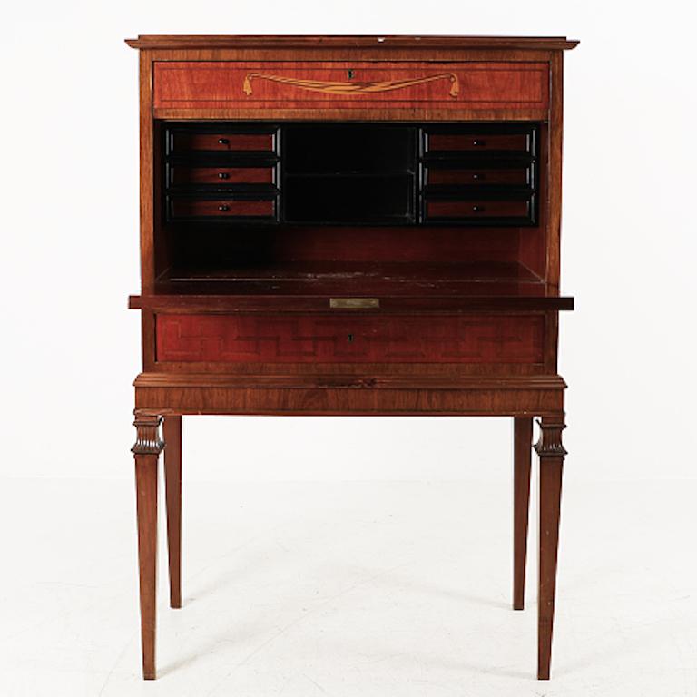 This early 20th century secretary has two drawers and a flap, with storage behind the flap. The flap opens by key, which is included. The secretary is approximately 50 inches tall.

Lovely piece, found in Stockholm and we just fell in love.