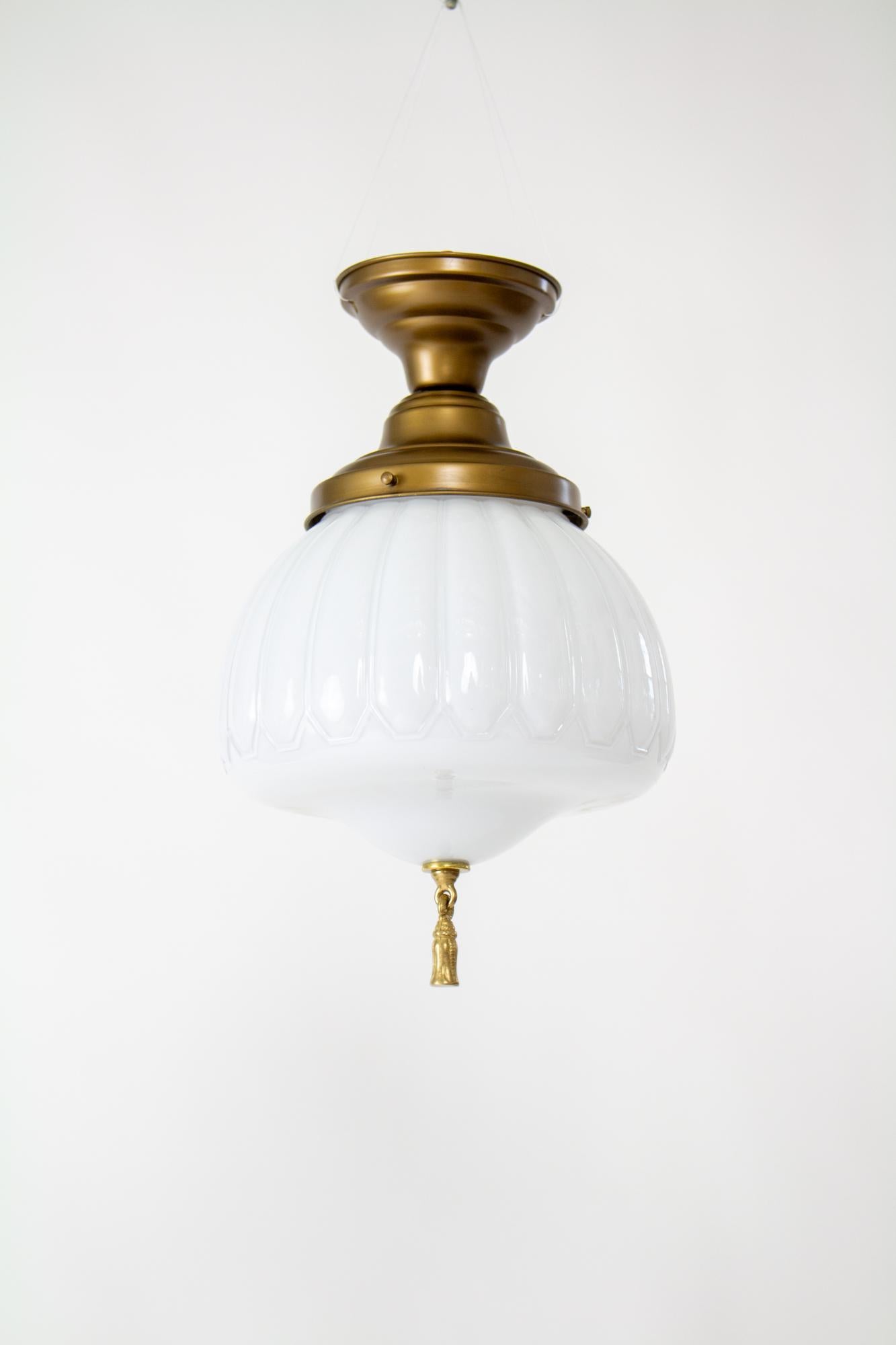 American Early 20th Century Semi Flush White Case Glass Fixture With Bronze Tassel For Sale