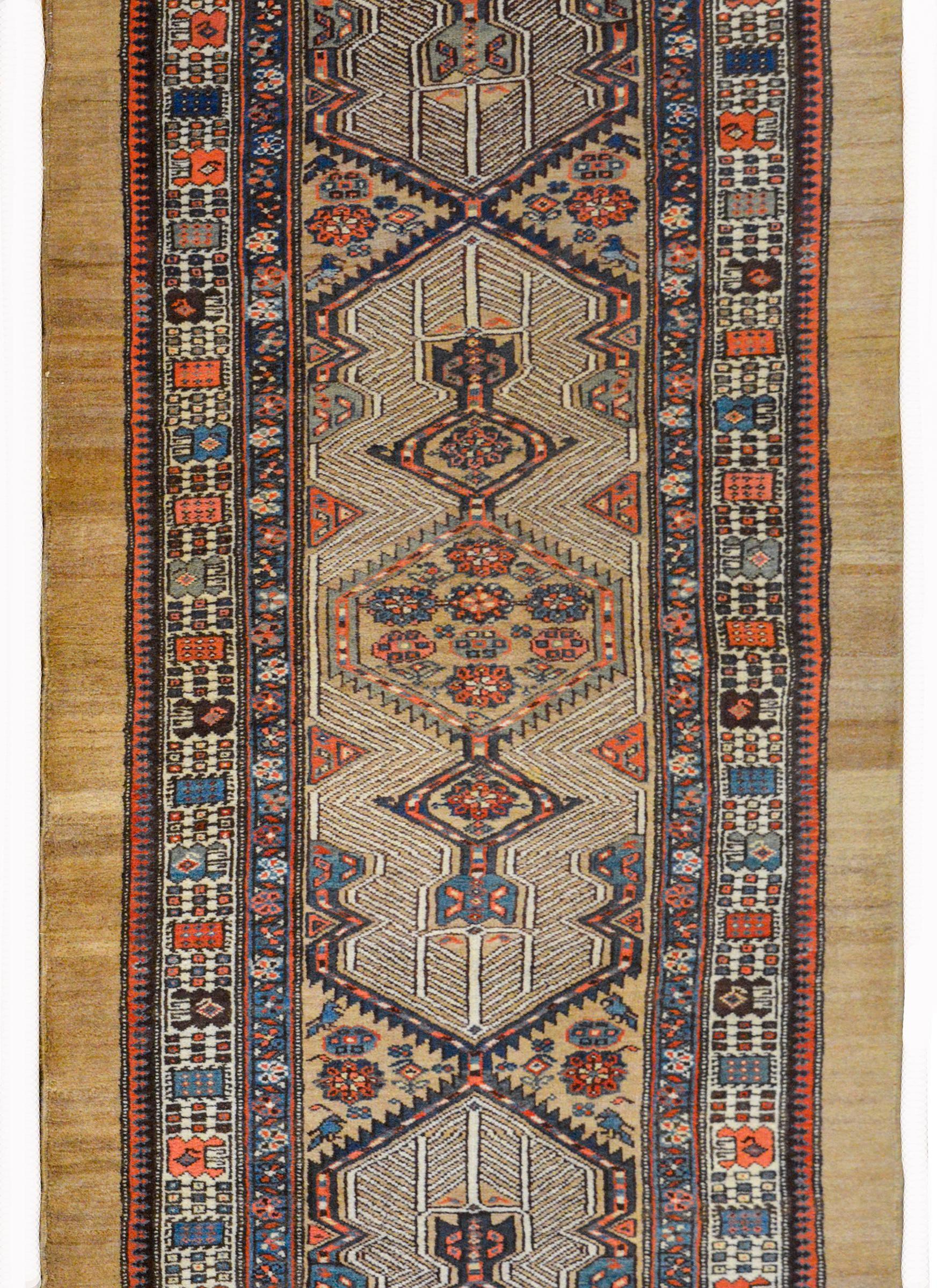 An outstanding early 20th century Persian Serab runner with an incredible pattern containing several geometric patterned medallions woven with stylized flowers surrounded stylized trees-of-life. The border is wonderful and composed with stylized