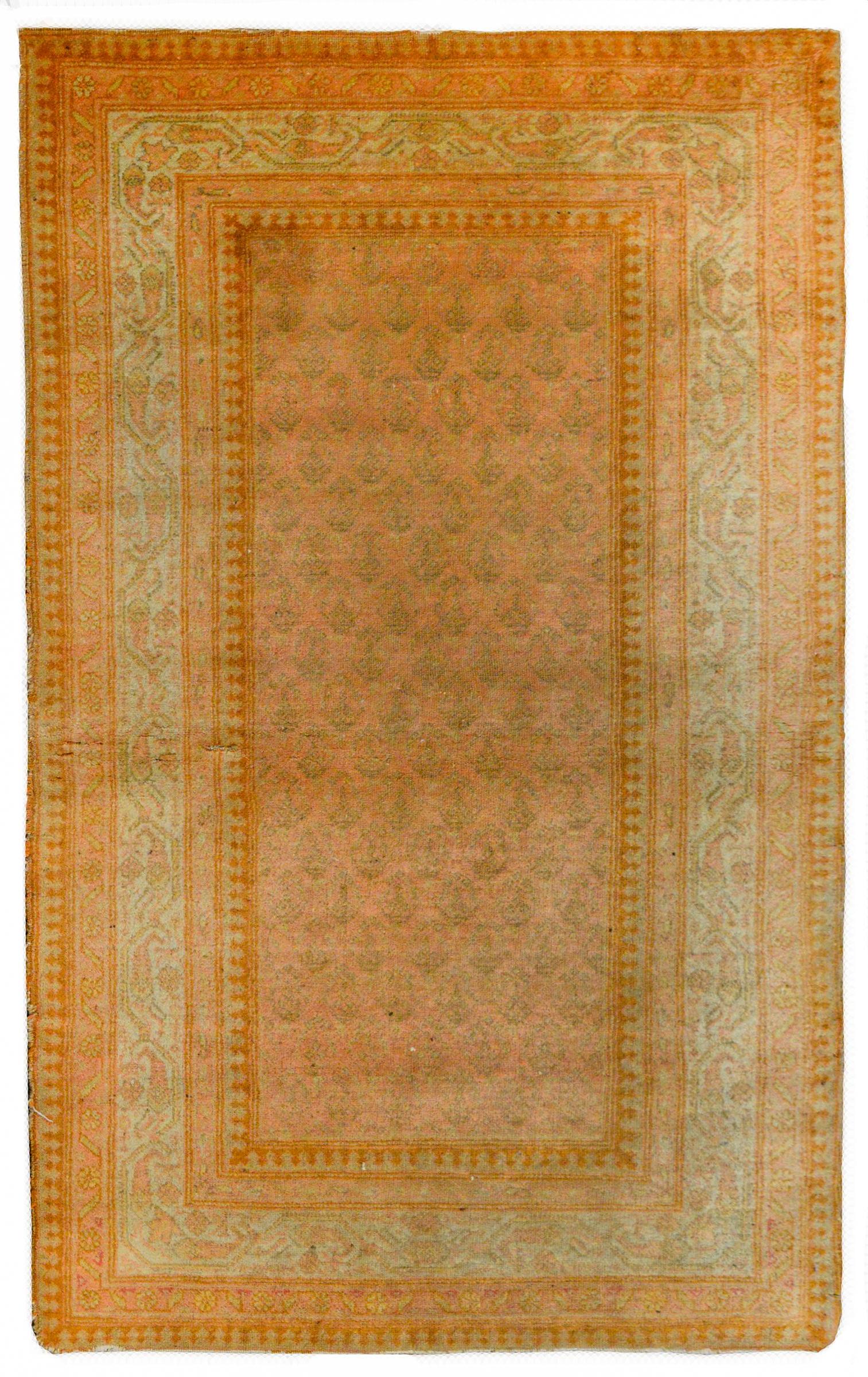 A wonderful early 20th century Persian Seraband rug with an all-over paisley pattern woven in a simple tone-on-tone pink and taupe color-way surrounded by a wide border containing multiple stylized floral patterned stripes woven in similar colors as