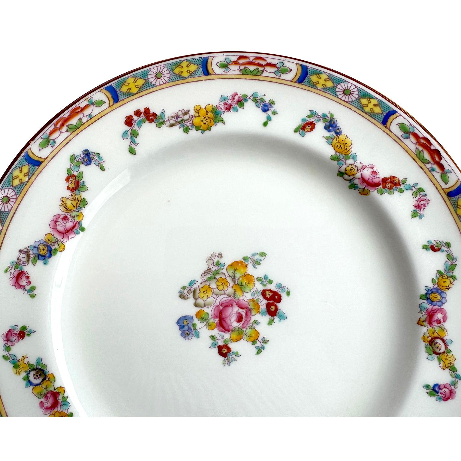 A Set of 22 English Hand-Decorated Minton Fine China Salad Plates. The beautifully vibrant color hand painted salad plates, each with a colorful floral design, an intricate trim and swaged floral strands, centered with a floral bouquet. All bearing