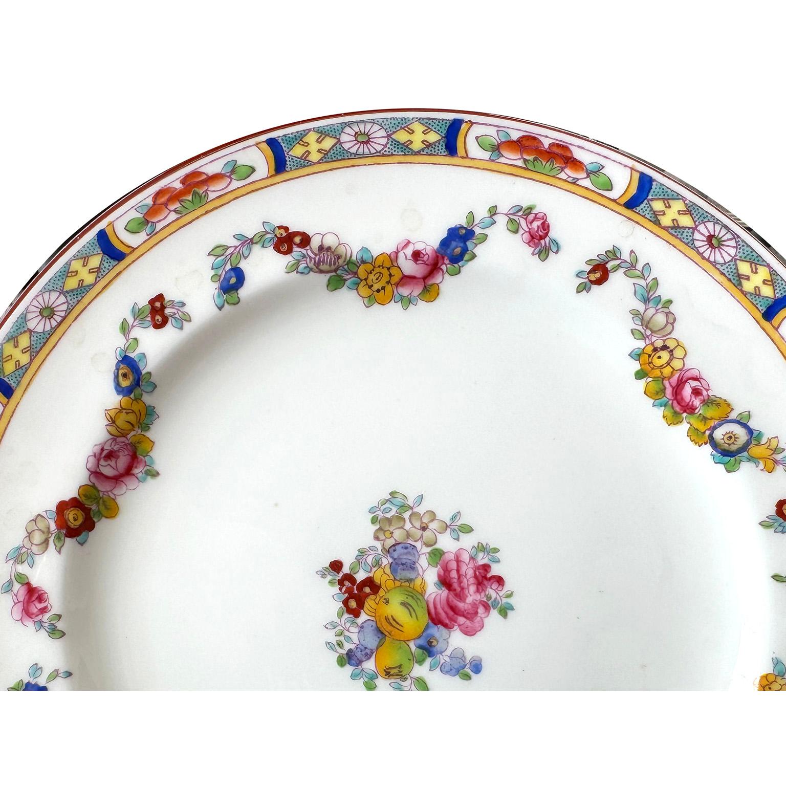 A Set of 30 English Hand-Decorated Minton Fine China Dessert Plates. The beautifully vibrant color hand painted dessert plates, each with a colorful floral design, an intricate trim and swaged floral strands, centered with a floral bouquet. All