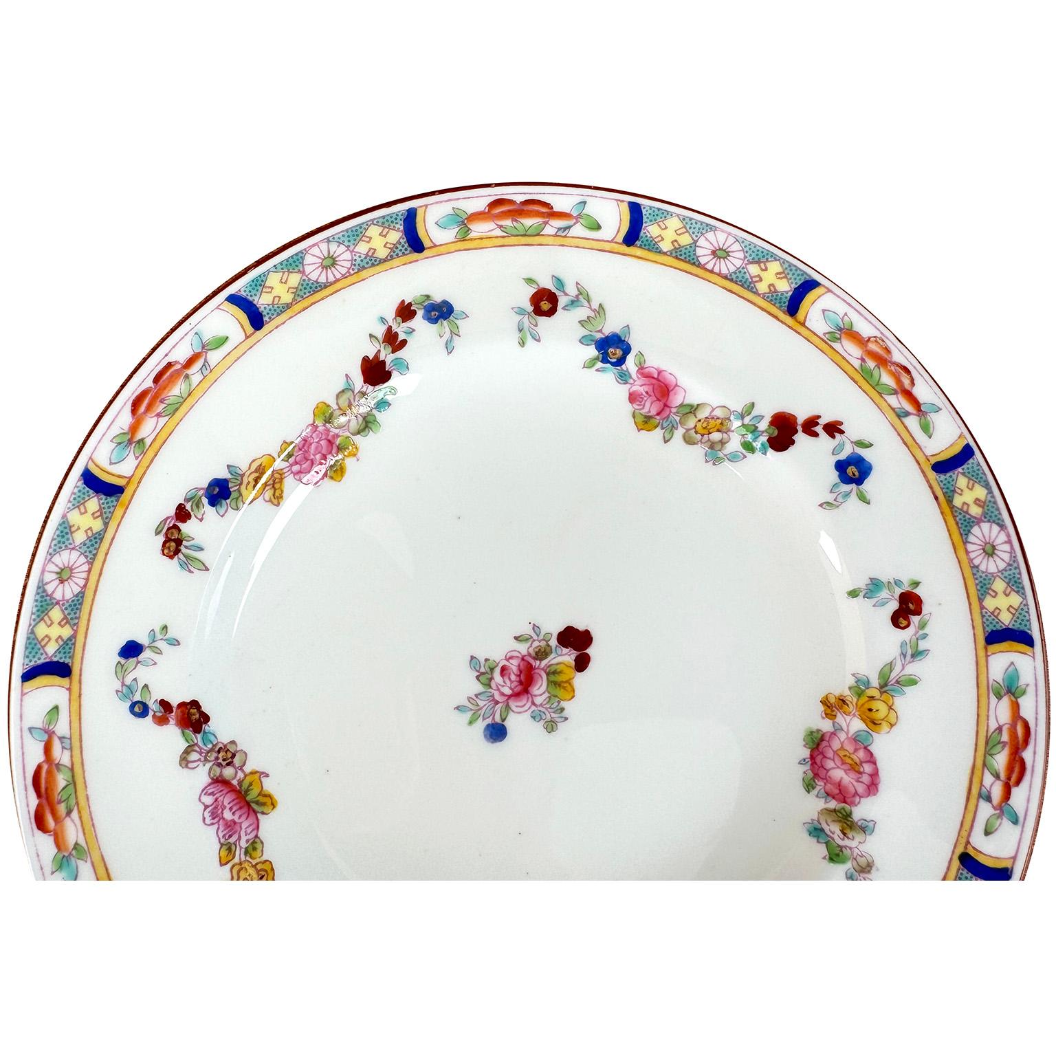 A Set of 36 English Hand-Decorated Minton Fine China Bread Plates. The beautifully vibrant color hand painted bread plates, each with a colorful floral design, an intricate trim and swaged floral strands, centered with a floral bouquet. All bearing