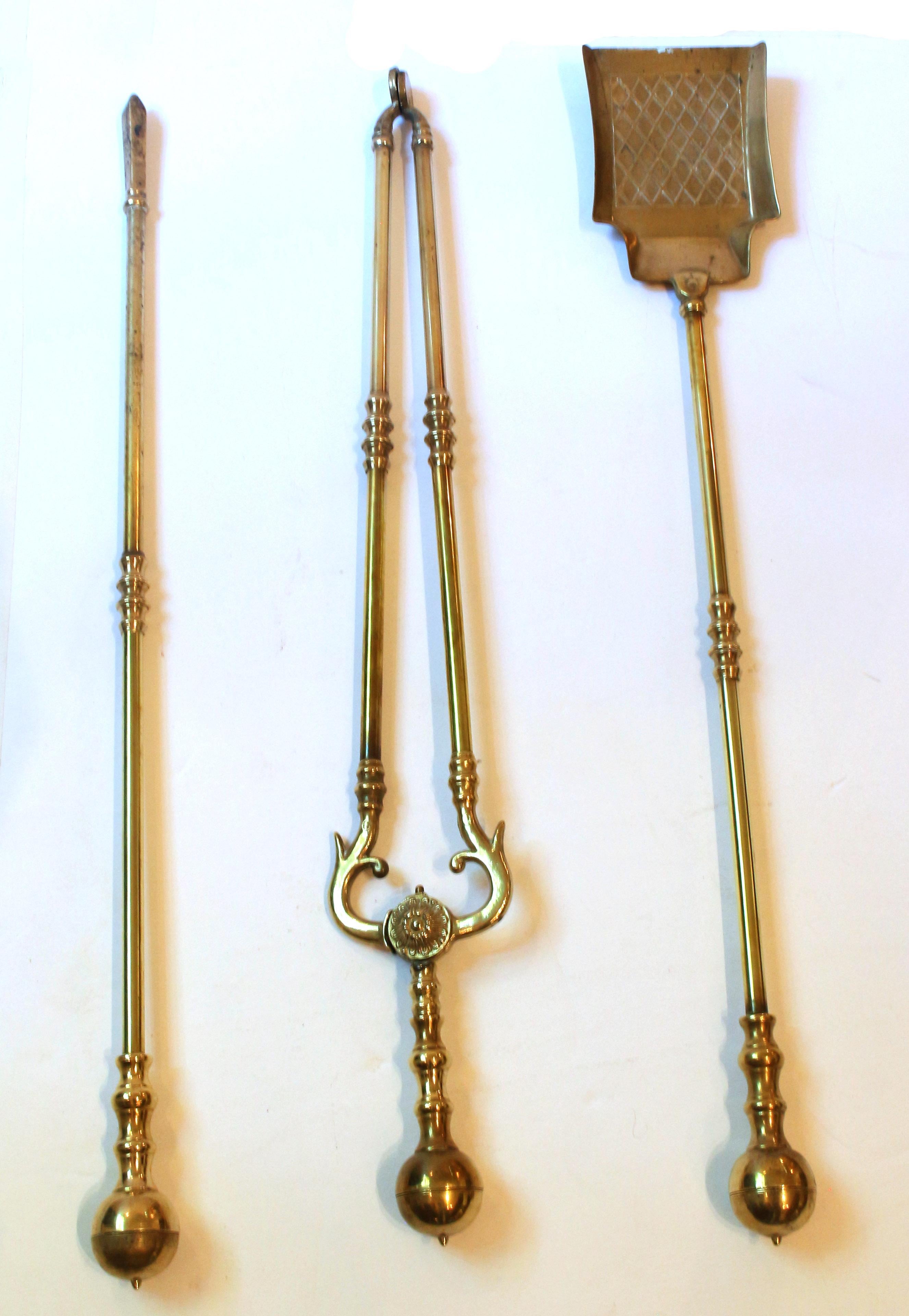 Early 20th century solid brass set of three fire tools, Anglo-American. Superb quality with large ball tops. Shovel, tongs & poker. Cast rosette medallion on tongs. Approx. 29