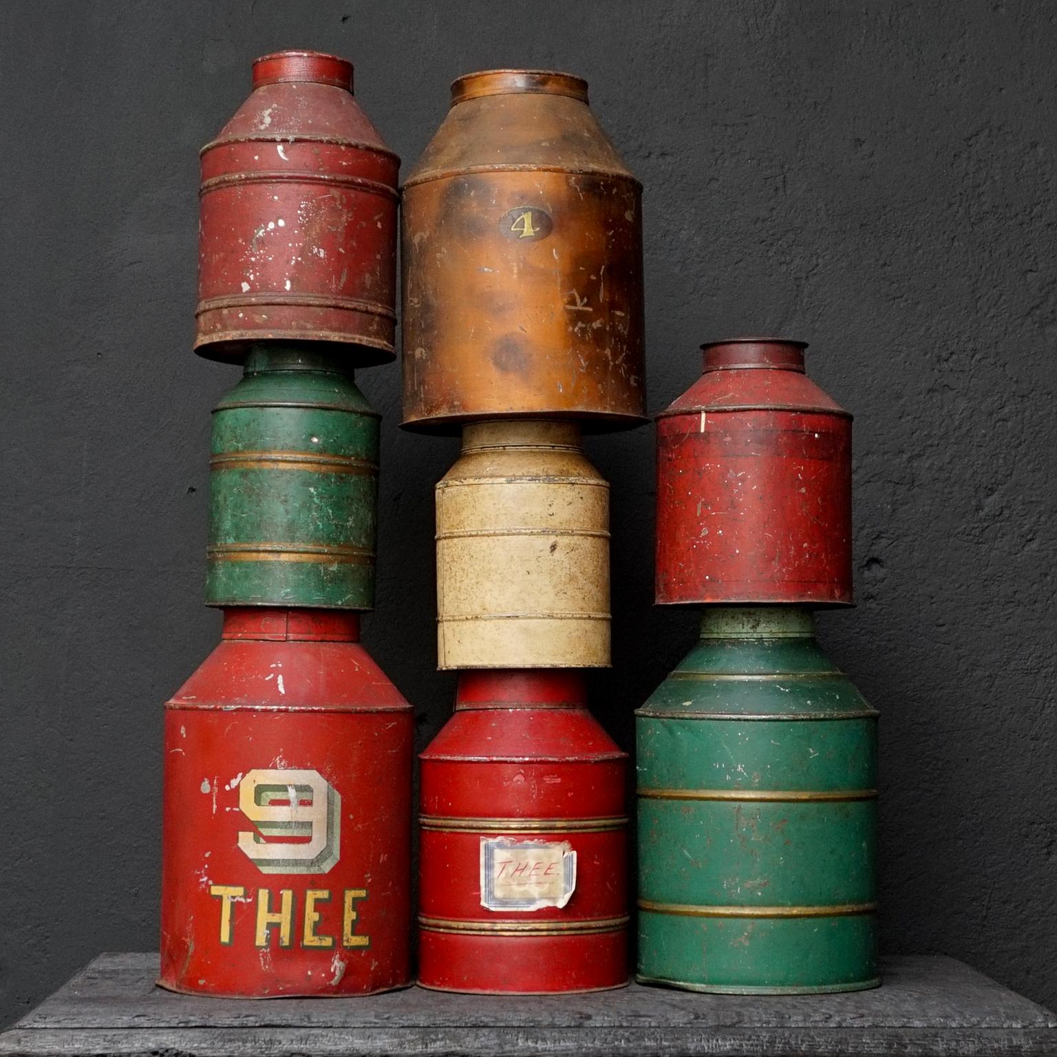 Highly collectable and very decorative this set of 8 antique Dutch tea tins or caddies.
These were used to keep tea in at the grocer's. Thee means tea in Dutch.

Big red tin with number 9 and THEE on it, 34cm high, diameter 22cm (13.4