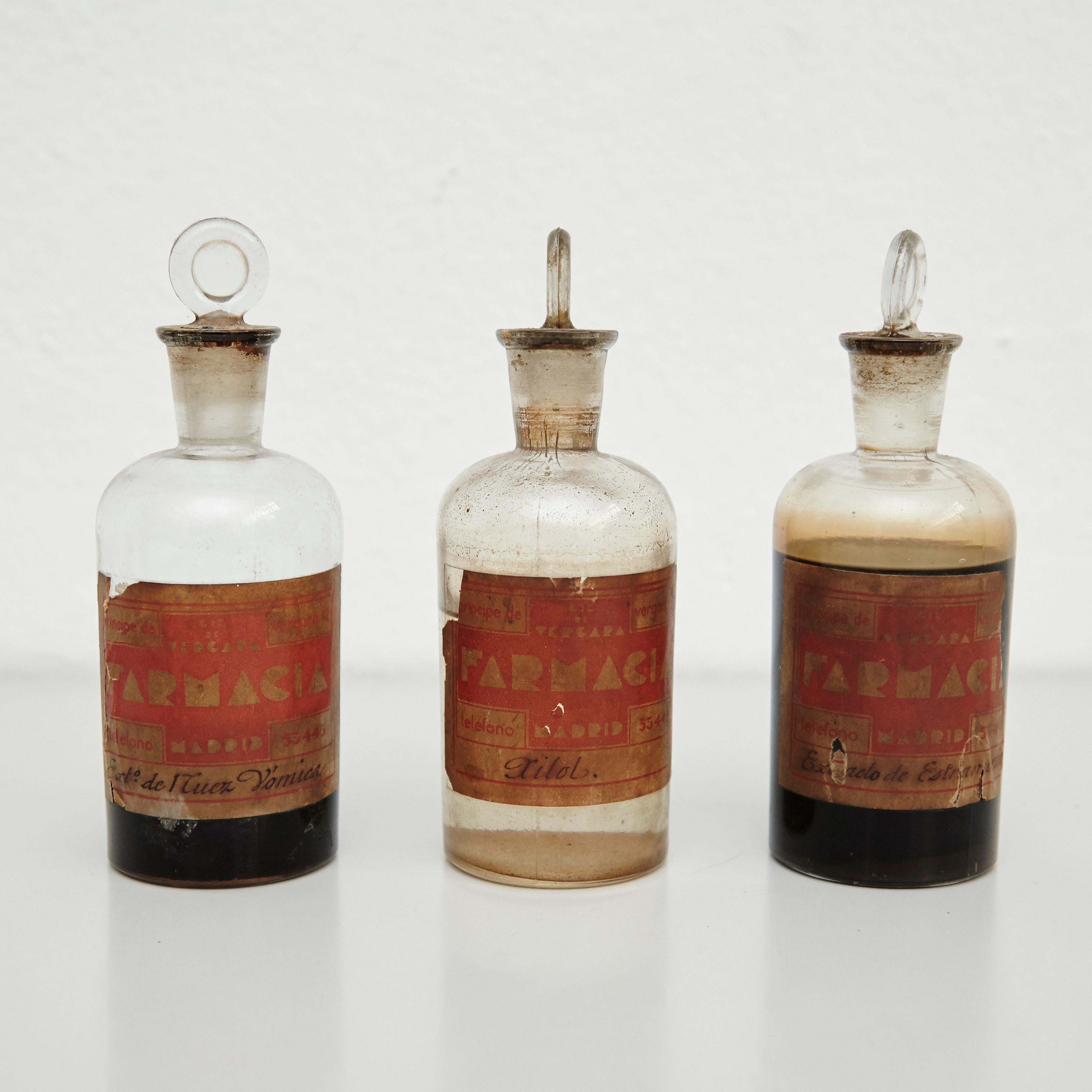 Early 20th century set of three antique apothecary glass bottles.
By unknown manufacturer, Spain.

In original condition, with minor wear consistent with age and use, preserving a beautiful patina.

Materials:
Glass

Dimensions (each