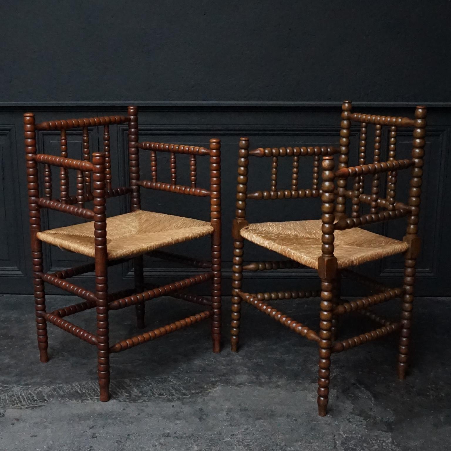 Very pretty set of two 1920s Dutch turned beech bobbin armchairs
The chairs were made in beechwood and both have rush matting seats.

Every section of the frame has a beautifully turned beech wooden structure that creates the bobbins.

This set
