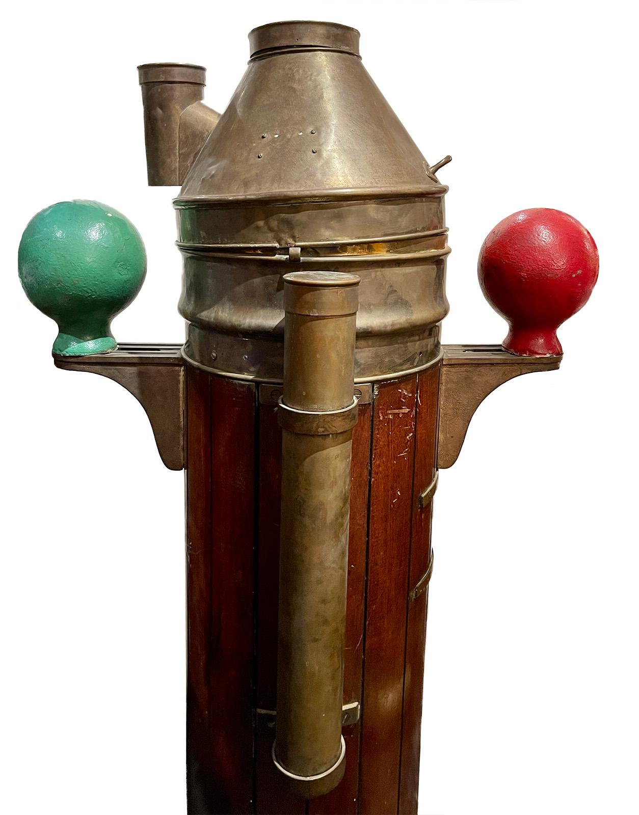 Solely made by Kelvin Bottomley & Baird, Ltd., Glasgow / London. Compass made by Henry Browne & Sons, Ltd. A standard binnacle form in brass housing with arms set with red and green painted iron Kelvin's balls. Small enamel dial on the front with