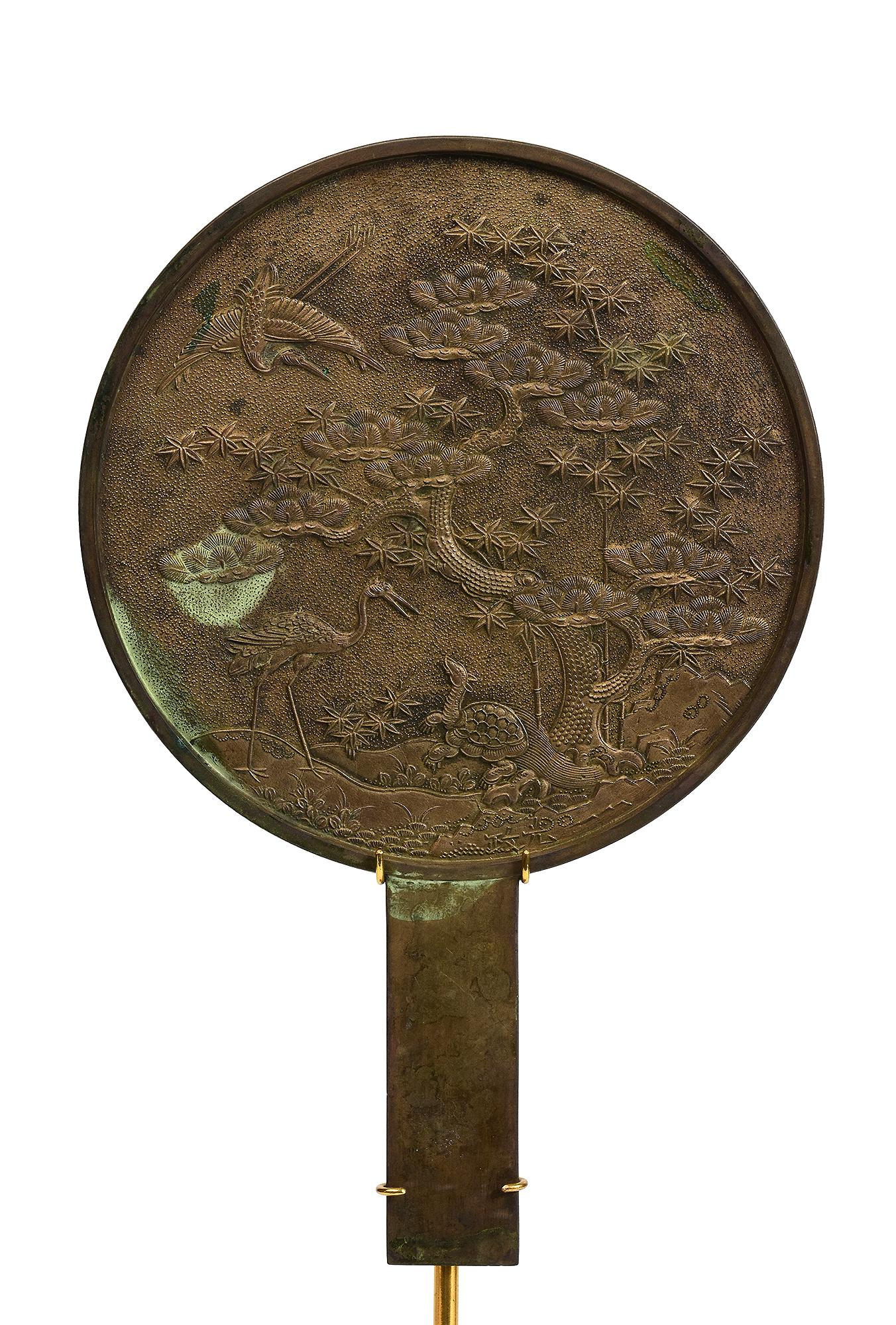 Japanese bronze mirror with stand.

Age: Japan, Showa Period, Early 20th Century
Size of mirror only: Diameter 18 C.M. / Height 27.8 C.M.
Size including stand: Height 43.3 C.M.
Condition: Nice condition overall.