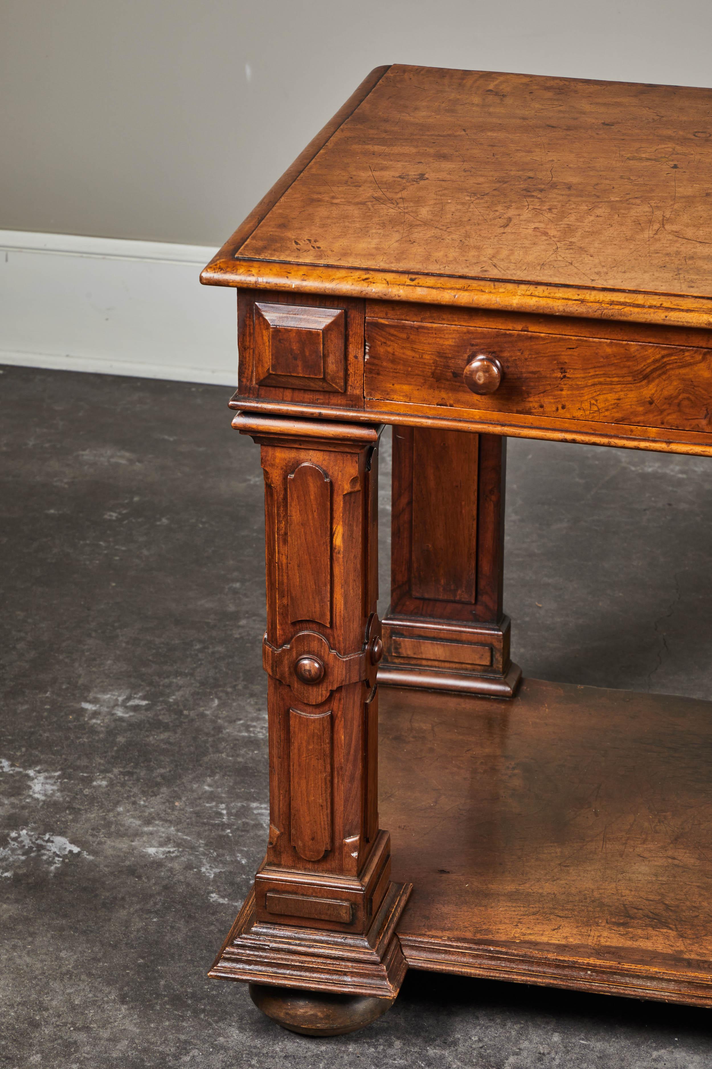 2 Drawer supported by four Baronial-Style legs with lower shelf.