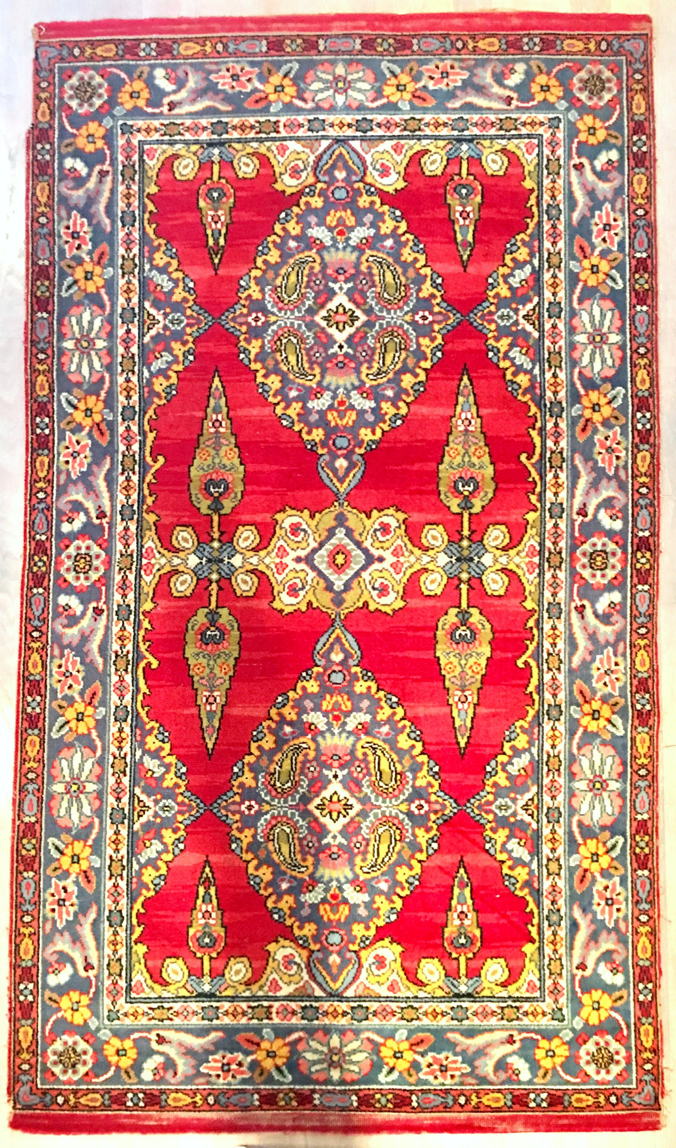 20th Century Classic Silk & Wood Paisley And Floral Blossom Indian Motif hand woven rug. Features, a vivid red ground with amethyst border accented by chartreuse, pink, white, yellow, and several shades of blue.
Most likely from India.
Measures: 3