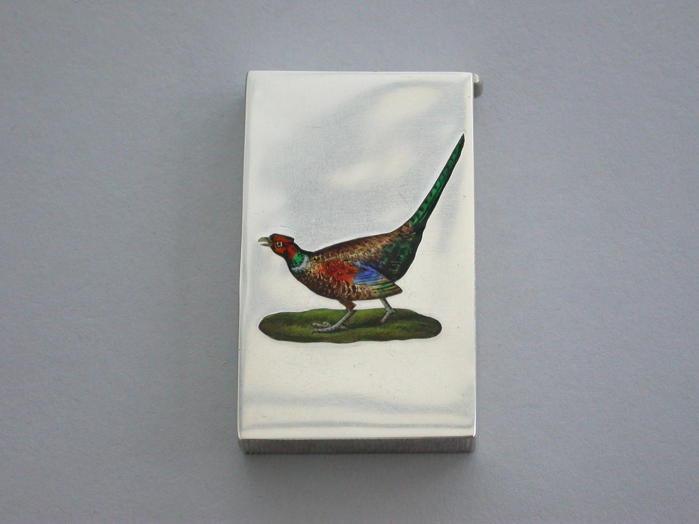 A fine quality early 20th century silver and enamel vesta case of flat-top rectangular form with sprung hinged lid, the face enameled with a cock pheasant.

By John Millward Banks, Chester, 1913.

  