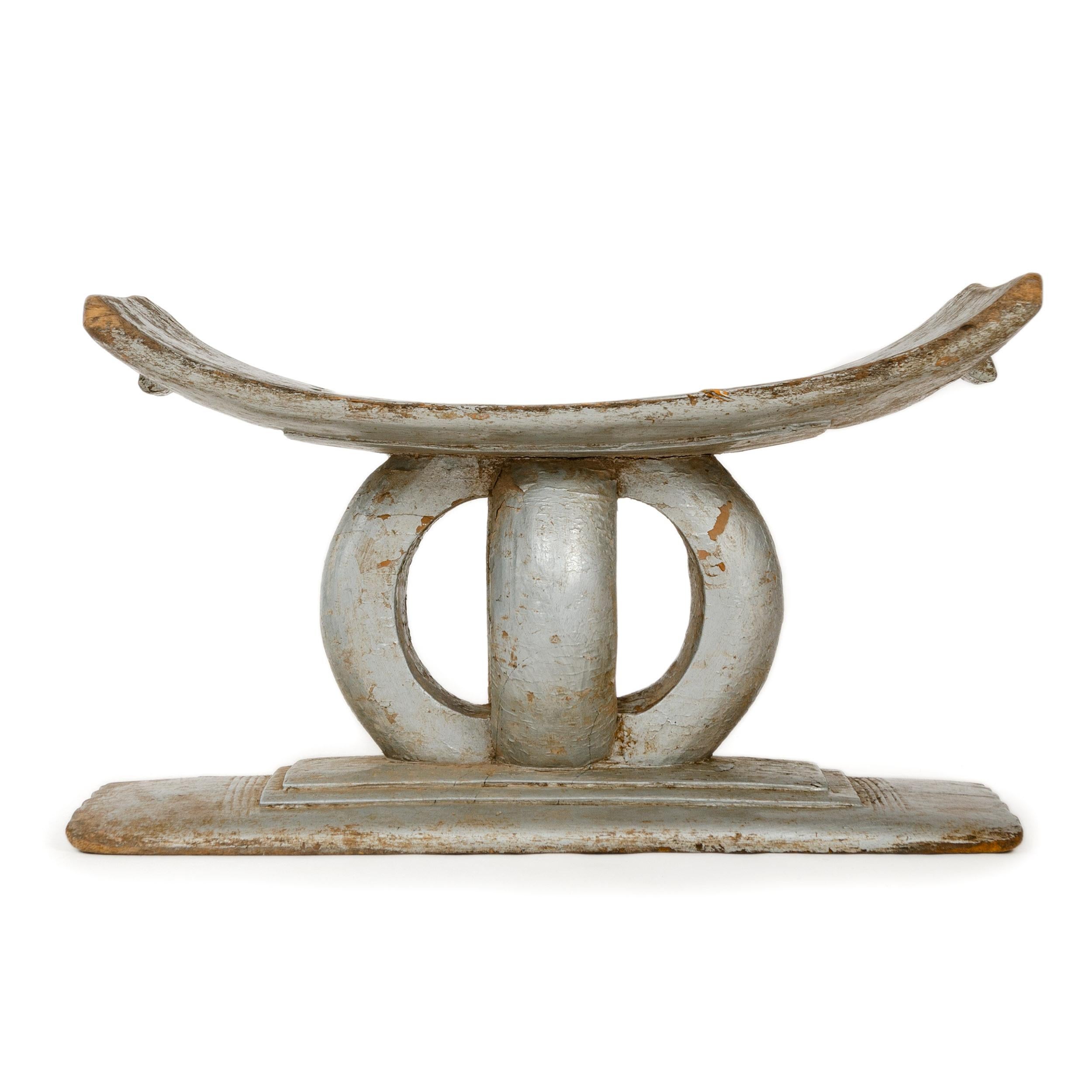 A large scale, hand carved and silver painted Ashanti tribal stool. Likely painted silver in the 1920s to compliment metallic trend of the Art Deco movement.