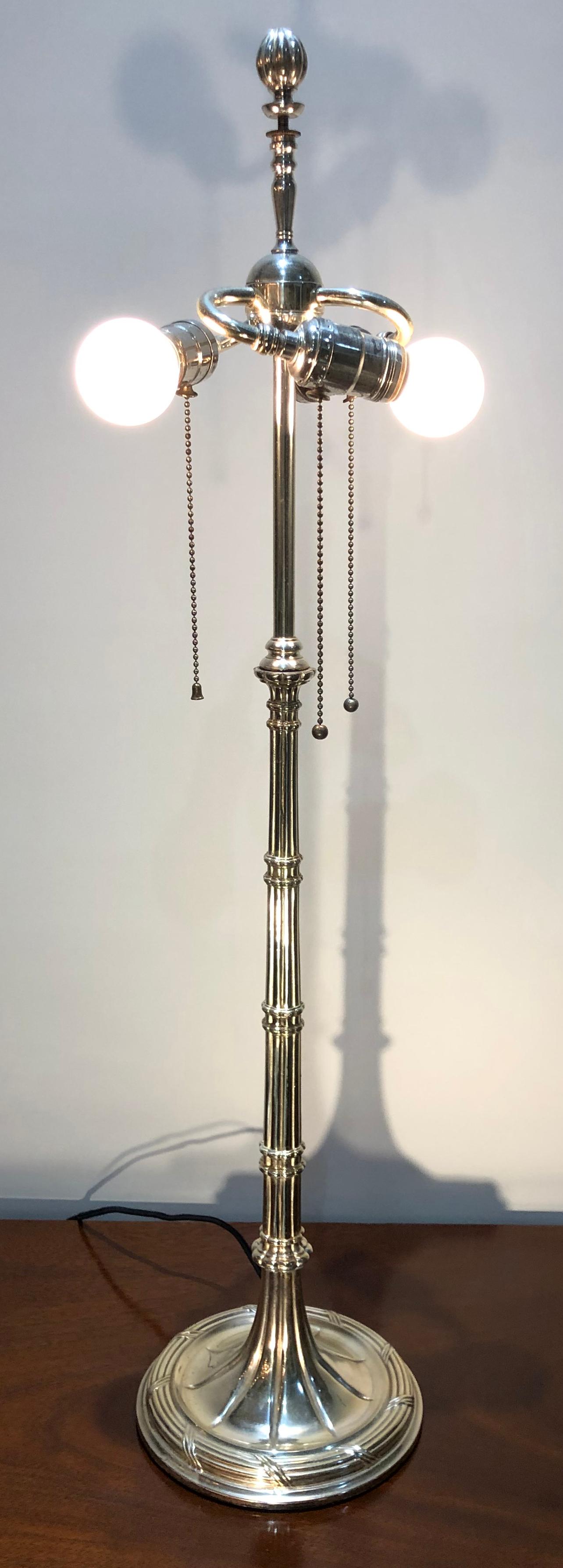 This early 20th century silver plate over bronze American table lamp with a faux bamboo design retains the original 3 light cluster. The lamp has been rewired with UL listed sockets.