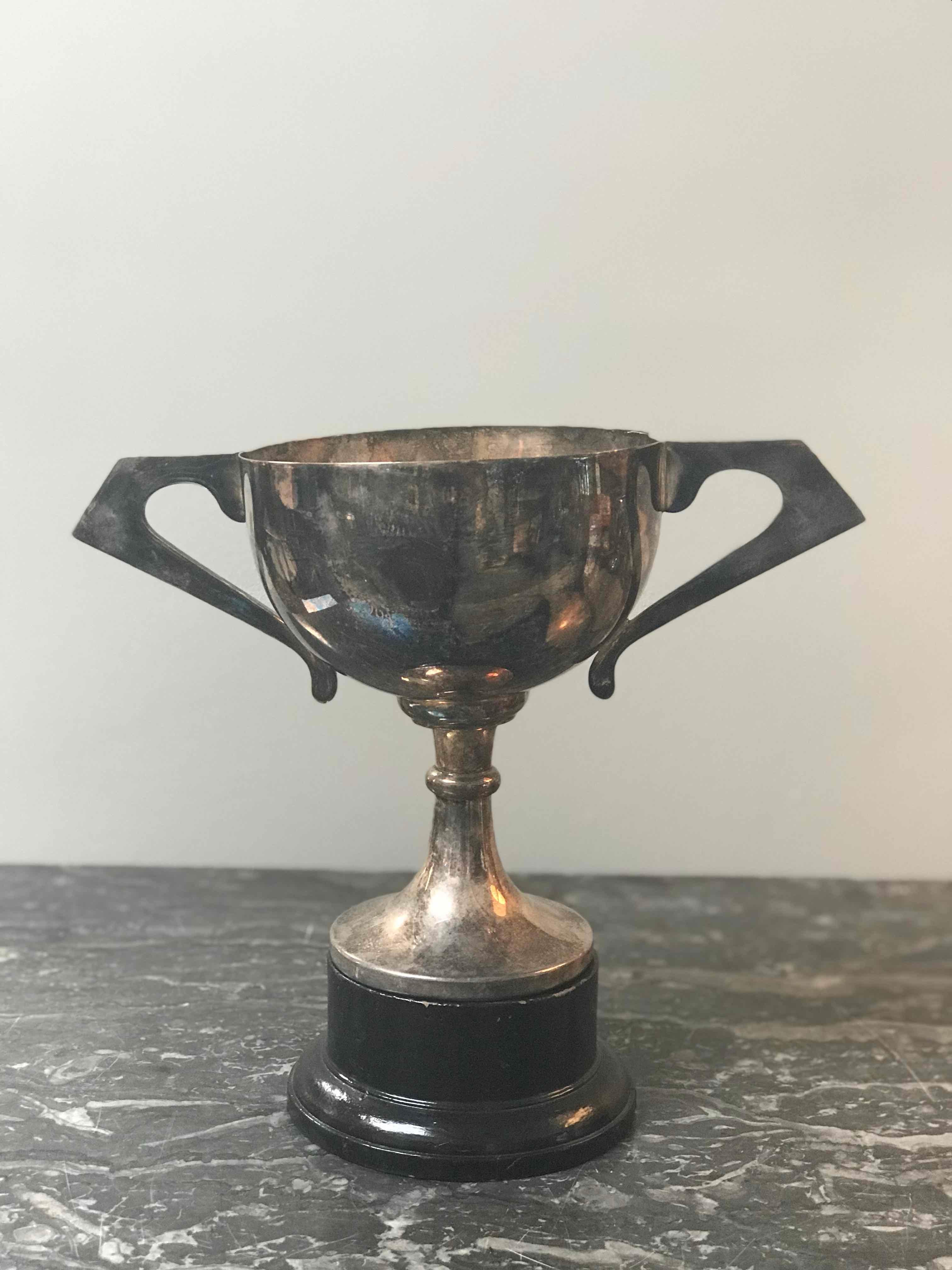 Early 20th century silver-plate trophy with handles on ebonized base. 