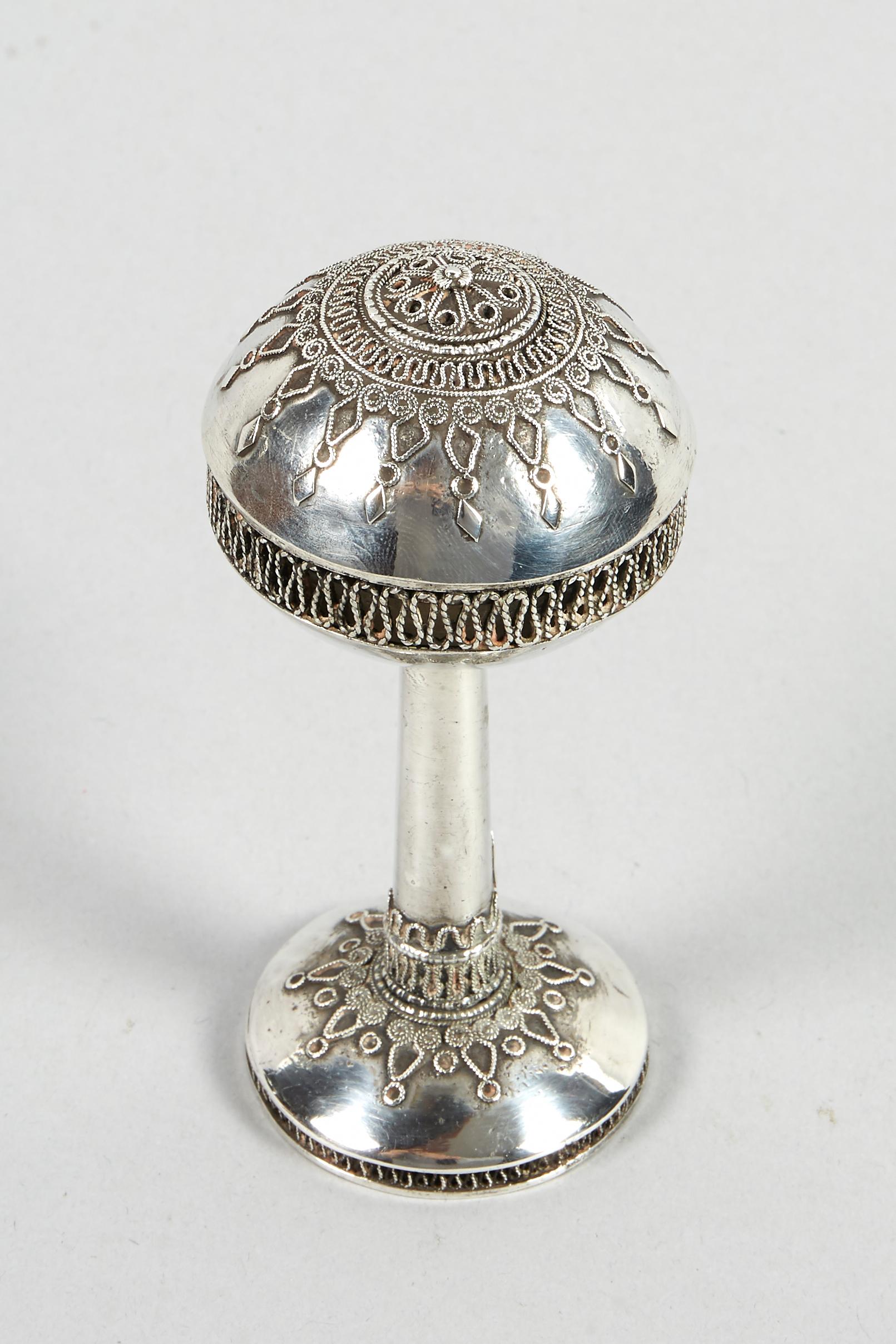 Silver and silver filigree spice container, Jerusalem, circa 1920. 
Ball spice container raised on a stem, On a round decorated base with filigree midsection. The lid is covered with matching filigree decoration to the base.
Marked 