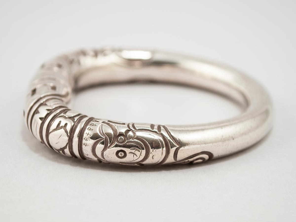 Early 20th century silver wedding bangle bracelet, China

This silver bangle bracelet is called a split bangle because the center is disconnected by a hair's breadth. These are also referred to as wedding bangles, and are hand-engraved with lucky