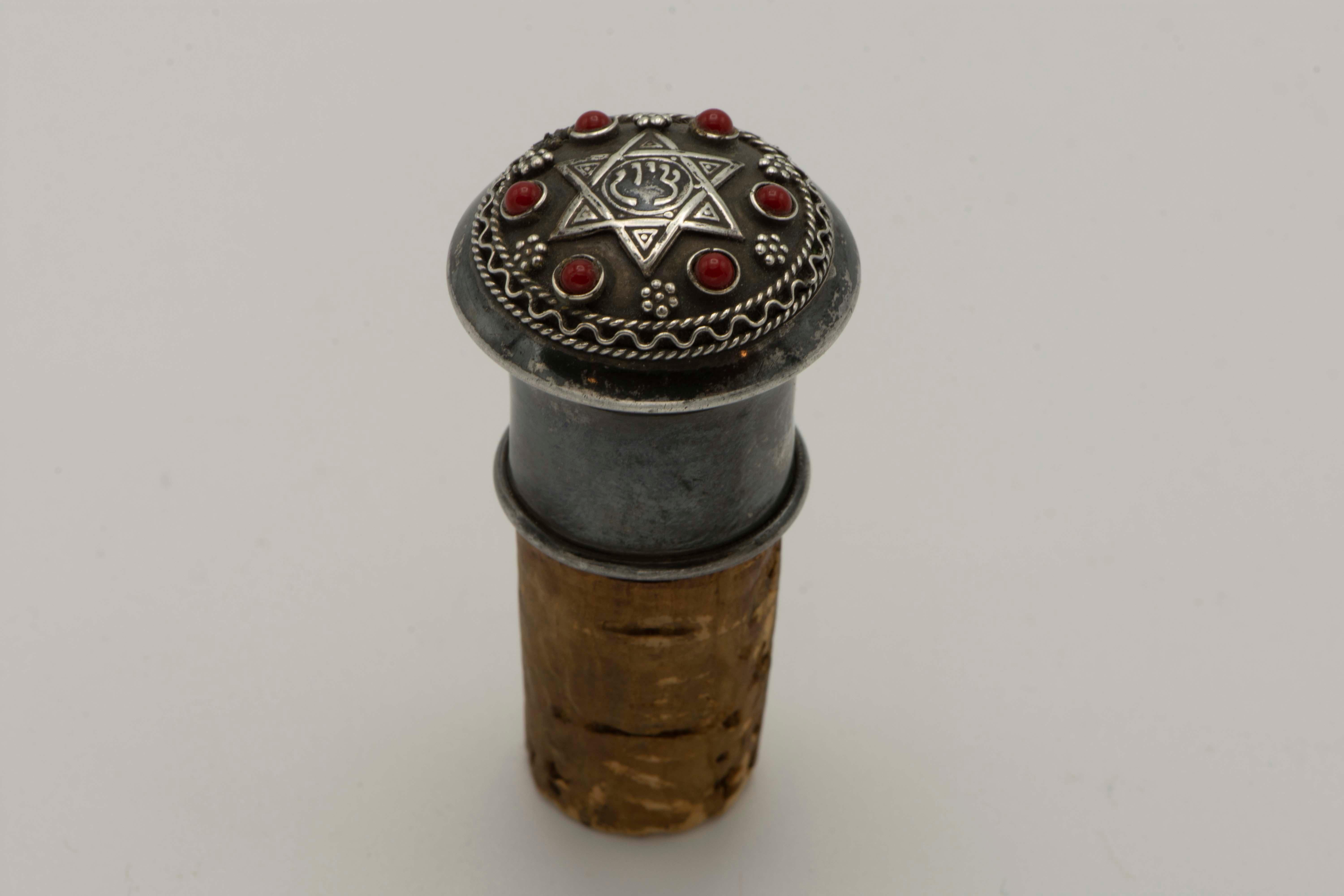 Silver wine bottle stopper by Bezalel school Jerusalem, circa 1920.
The top is decorated with silver Star of David with the hebrew word 