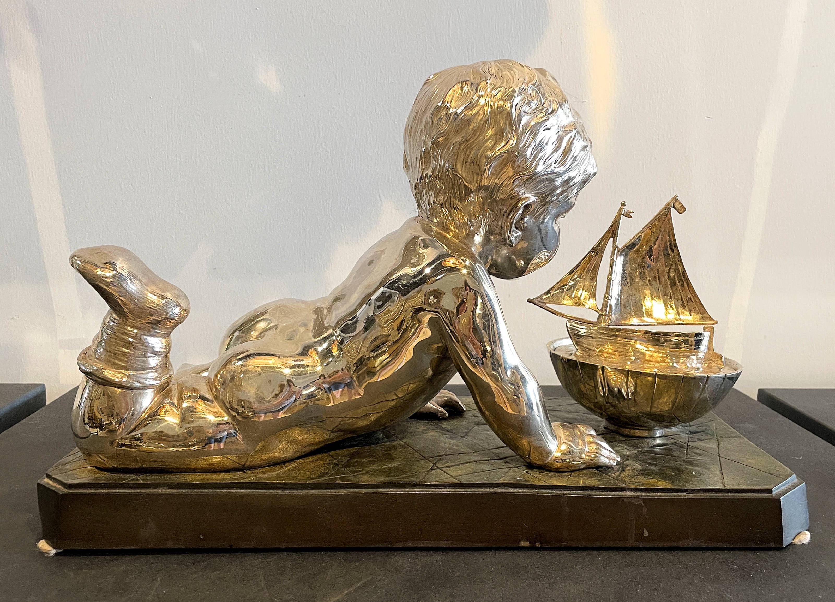 French Early 20th Century Silvered Bronze Enfant Jouant Avec Un Bateau For Sale