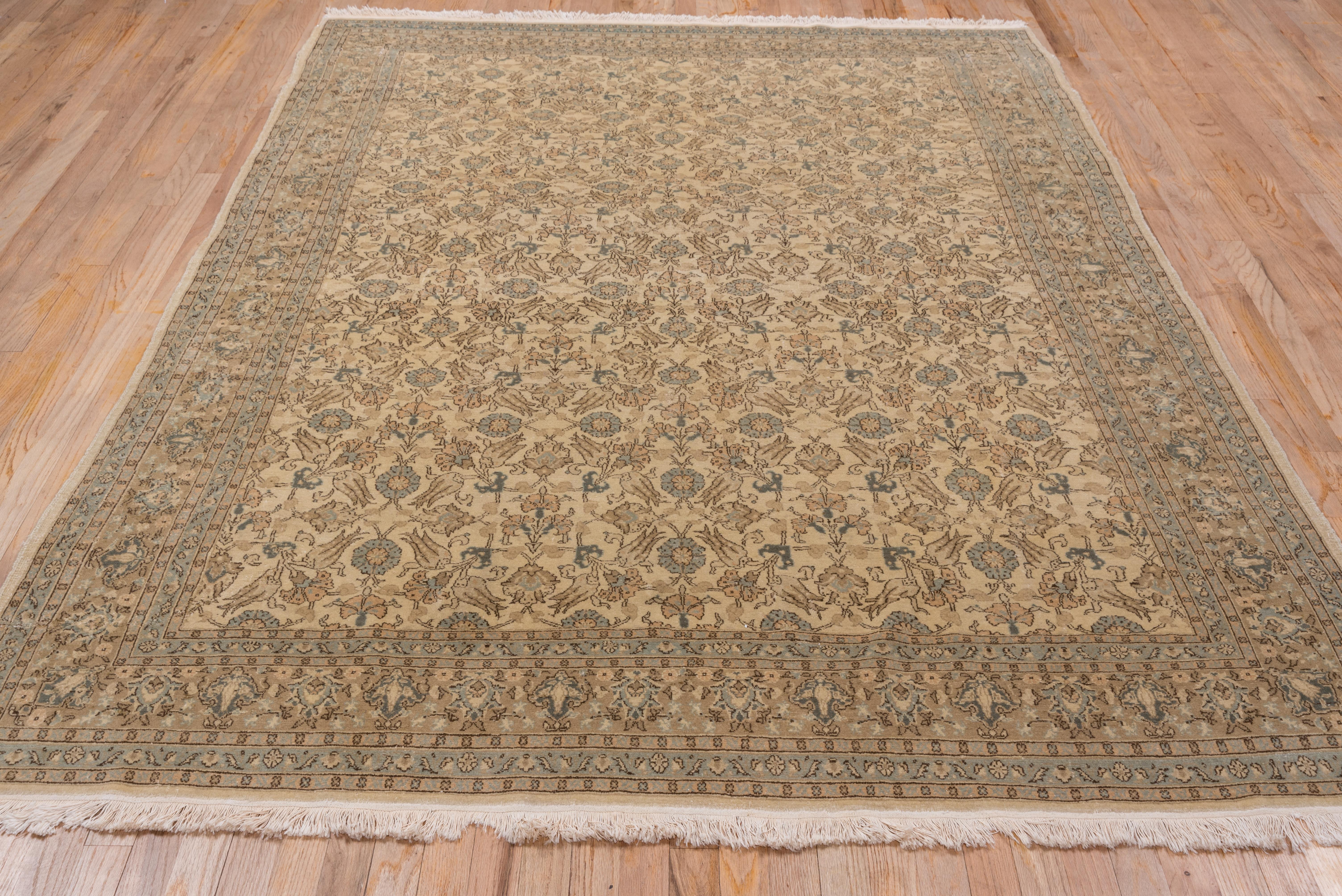 This finely woven eastern Turkish urban rug features a sandy ivory field with an alloer pattern of Ottoman-style tulips and carnations along with arabesques, rosettes and palmettes in dark brown, green and buff. The buff main border shows two types