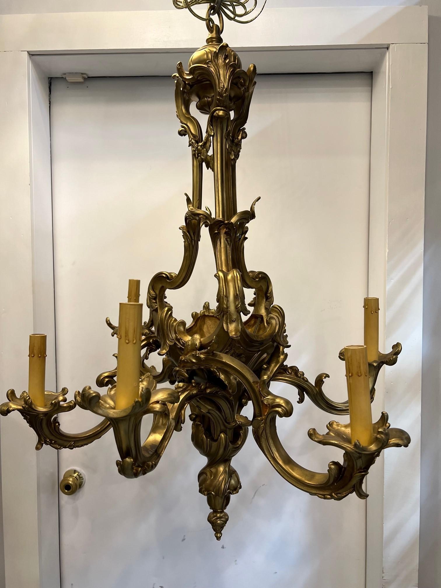 Antique Louis XV style bronze chandelier with Rococo influence. A graceful French Rococo style five arm gilt bronze chandelier recently rewired from an estate in Westchester County NY.  
