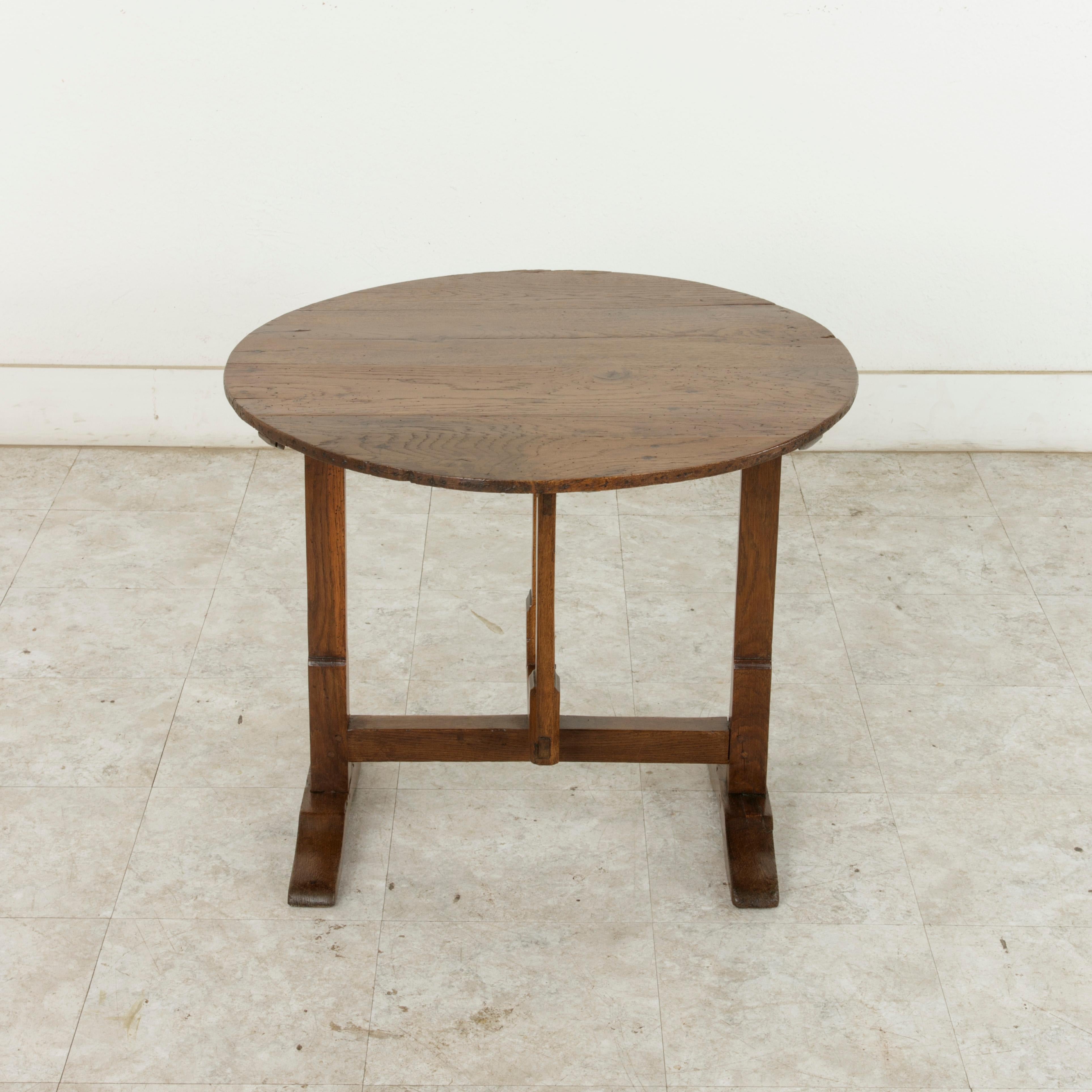 A perfect piece to finish a wine cellar or bar area, this small scale hand pegged oak vineyard table was originally used for wine tasting in the wine cellar of a vintner or for carrying out to the vineyards for the grape pickers to eat lunch.