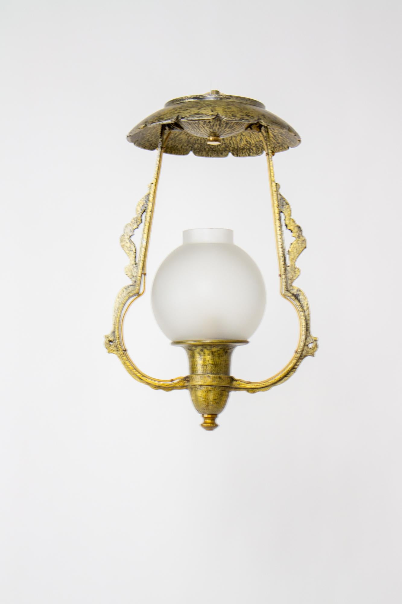 Small hall light, tudor or storybook style. Hammered metal look in cast aluminum. Brass finish. Unusual rounded globe. The lantern mounts flush to the ceiling so it is excellent for a small space and low ceilings, as low as eight feet. Completely