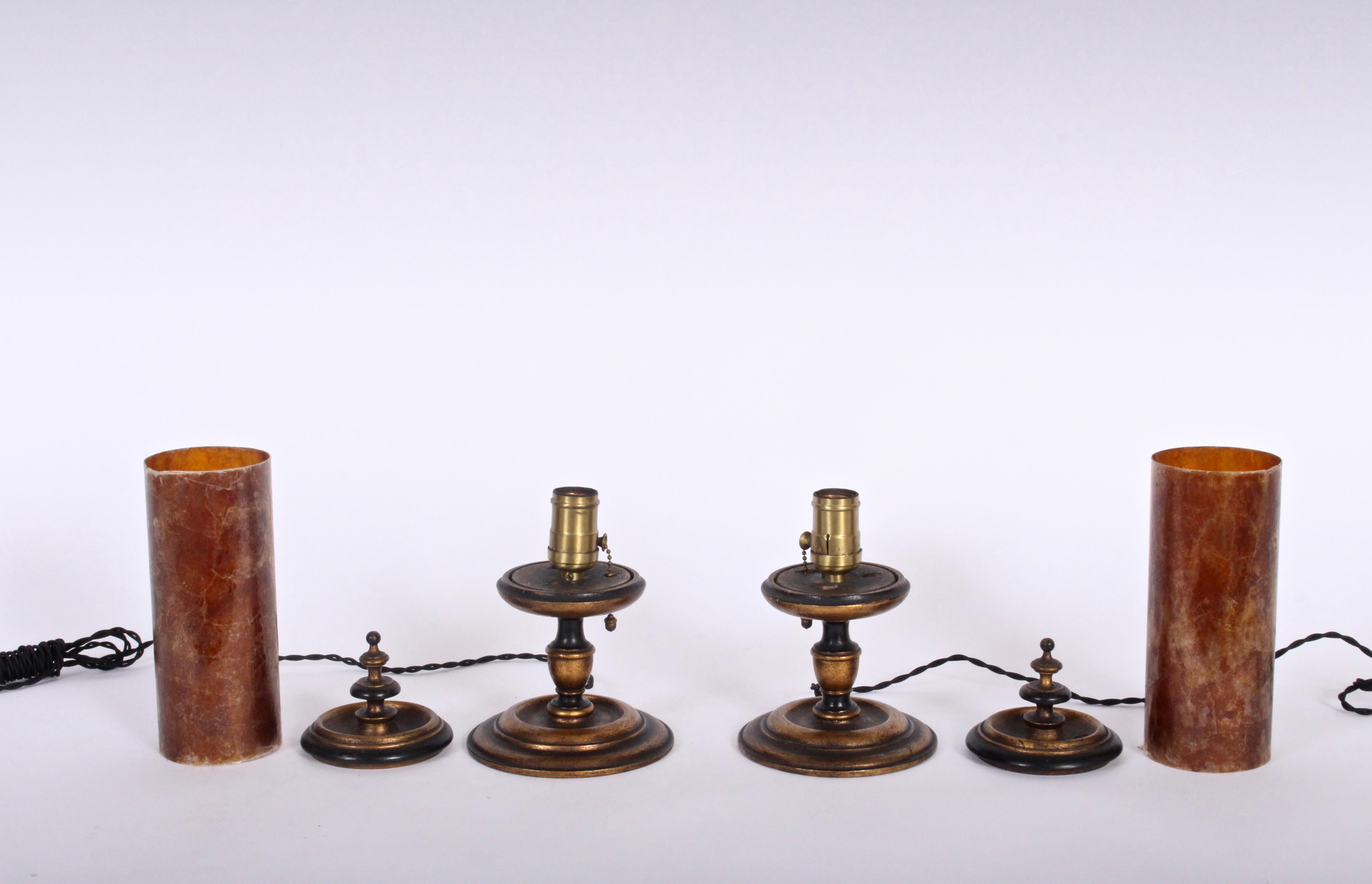 Smaller pair of Italian Revival mottled Crimson mica shade table lamps, circa 1920. Featuring warm, reddish orange mica cylinder shades (3 D x 8 H) with round antique gold gilded base and cap. Pull chains. Arts and Crafts. Accent. Statement