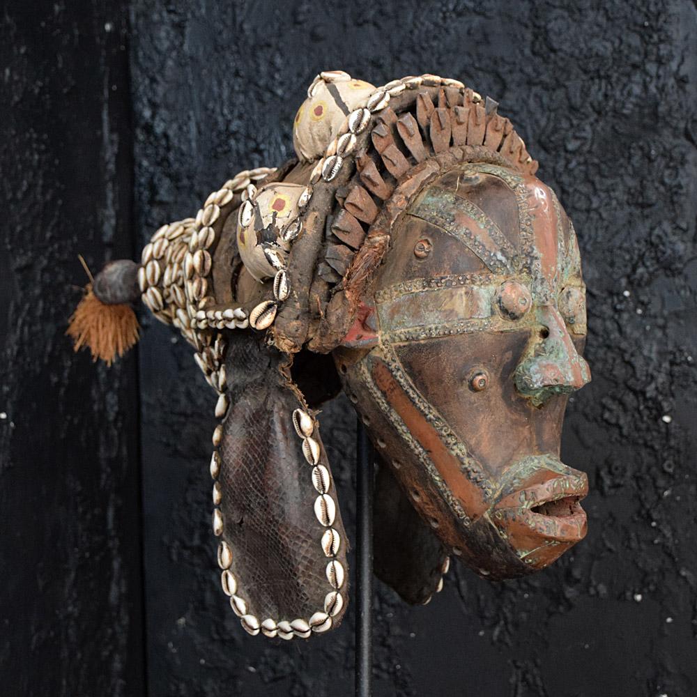 Early 20th century Snake Man Mask
We share what we love, and we love this early 20th century hand crafted Dan mask. Made from snakeskin, shells, wood, canvas, copper, metal, and brass. A very sculptural, artistic, and unusual object. 
Size of