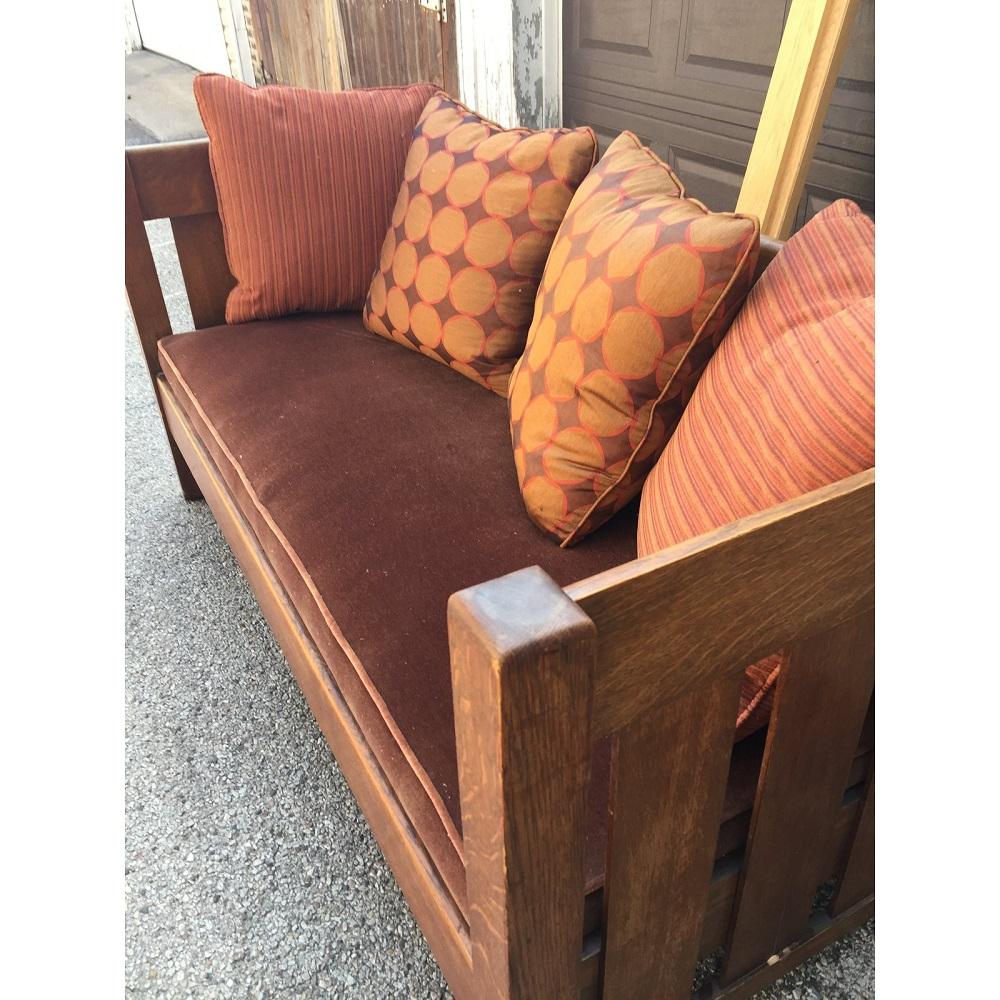 Arts and Crafts  Sofa Phoenix Furniture Company
Since 1870 chairs and settles have been manufactured by the Phoenix Furniture Company. This Original settle from 1904, has been reupholstered in velvet and the silk toss pillows included will add