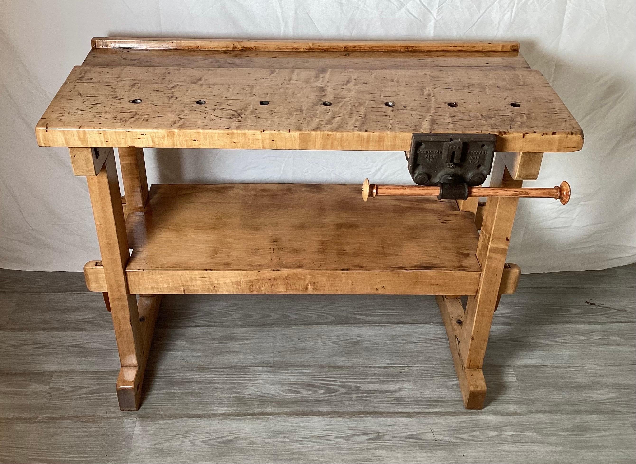 A diminutive solid American maple workbench with vice. The smaller size, 41 inches wide with refurbished finish but still retaining all the character of age and use.