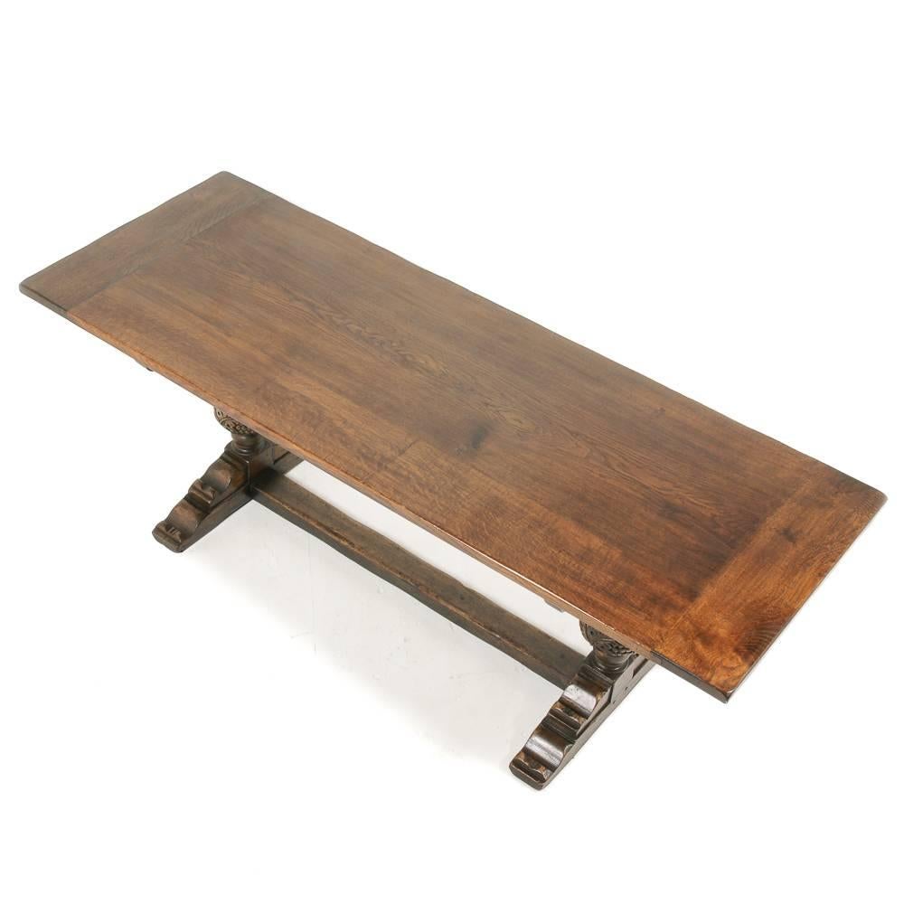 Beautiful color and patina on this dark, solid oak, early 20th century trestle table from England.