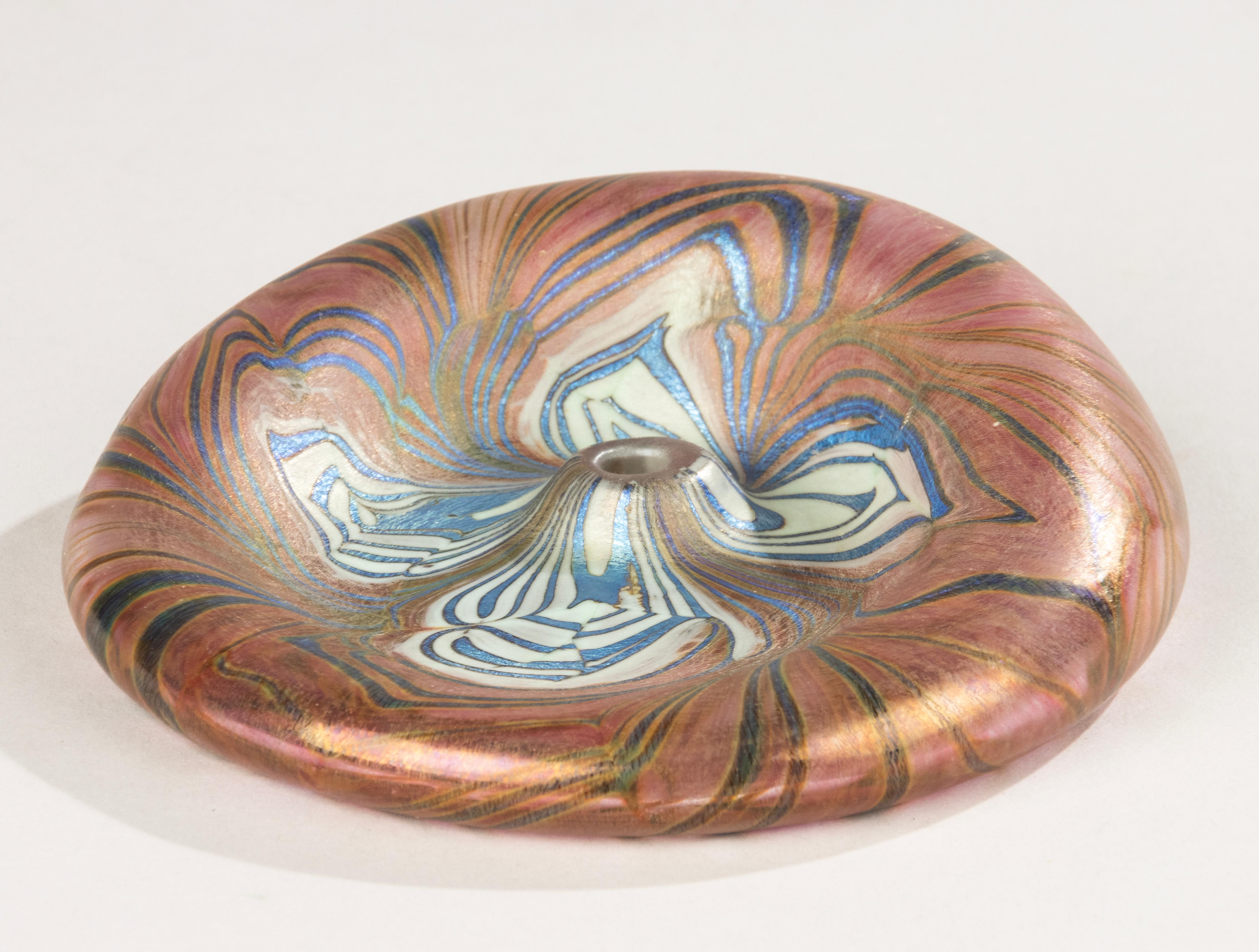 A striking Art Nouveau soliflore vase, designed to hold a single flower – it would look particularly beautiful with a peony. The piece features a mesmerizing iridescent surface with swirling marbled patterns in pink, blue, cream, and gold, forming