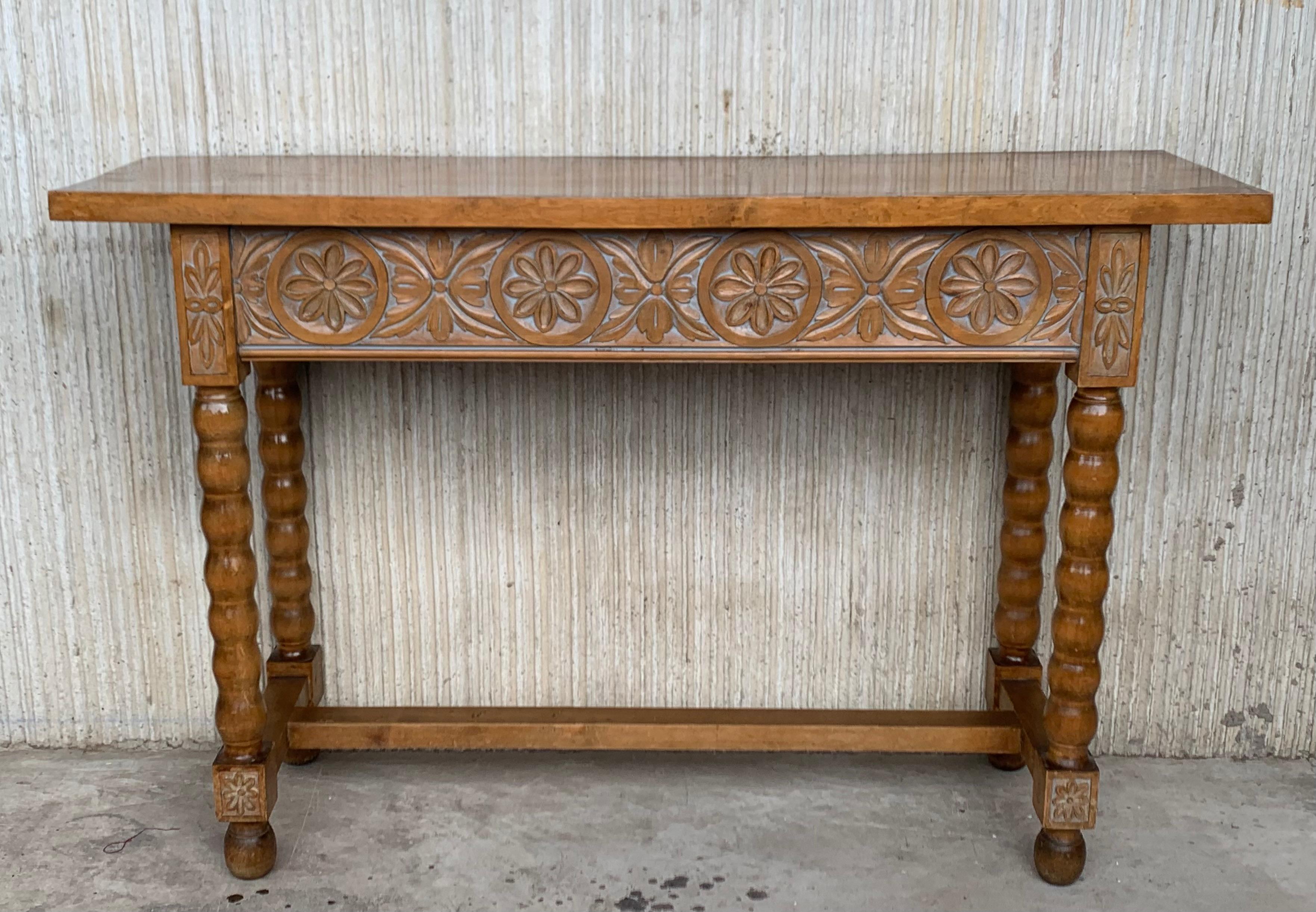 This characterful table is of rare narrow depth of 15in. It is characteristic of Spanish Baroque furniture with a thick single piece top, simple bold chip carved ornament and bold turnings. It has a rich lustrous patina. The thick single plank