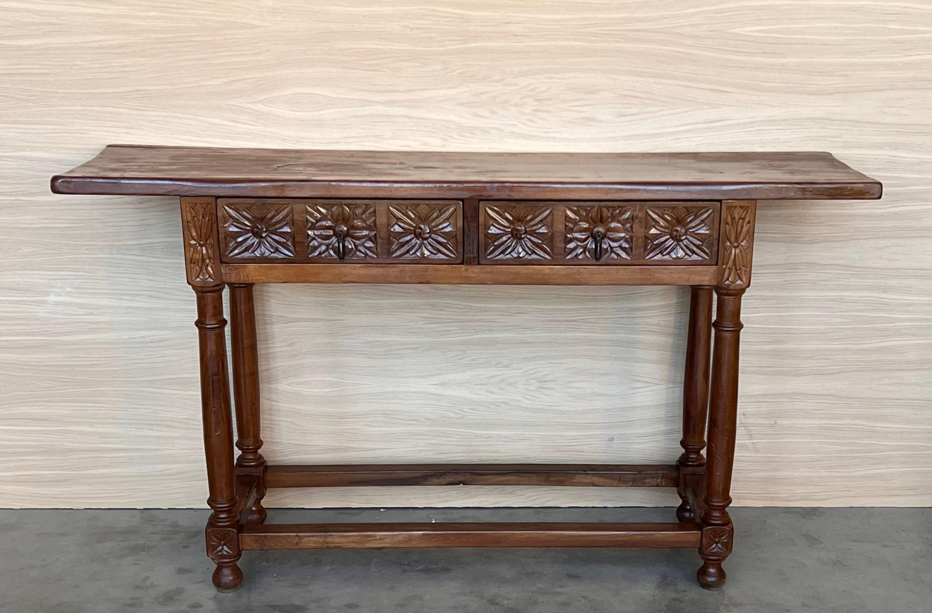 Early 20th Century Spanish Colonial Walnut Console ~ Sofa Table is a splendid reminder of a bygone era! Hand-crafted from old growth walnut, it features a single thick plank of solid walnut serving as the top surface. A casework that contains two