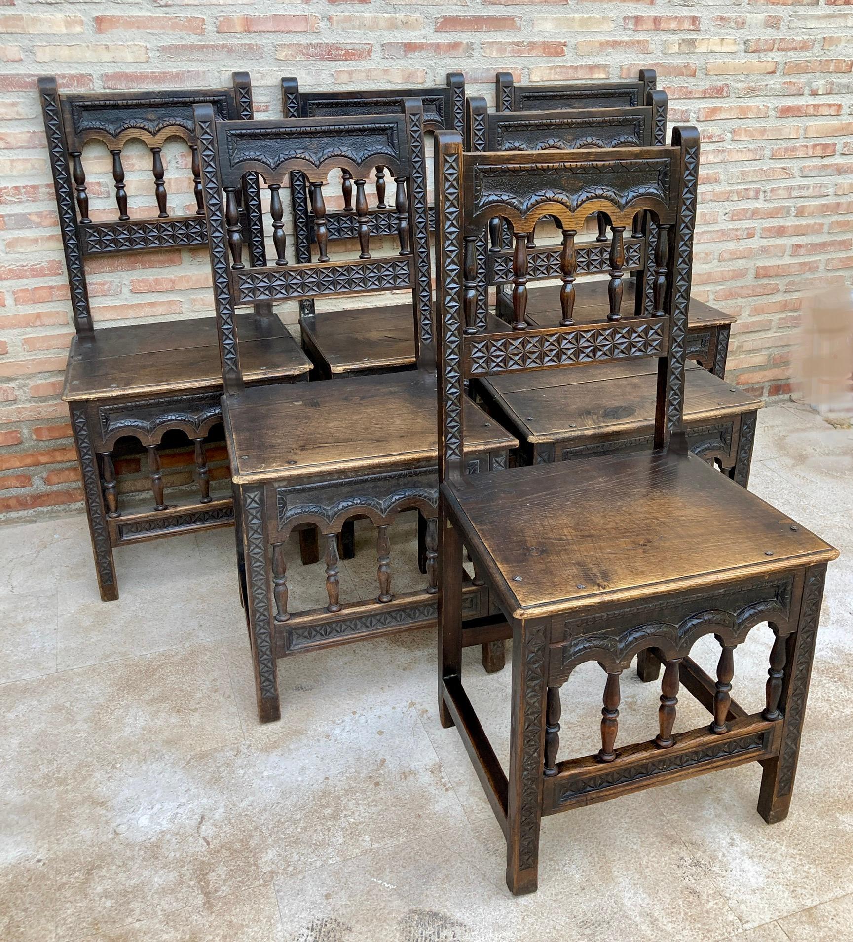 A set of 6 Spanish chairs with oak wood seat on walnut and sycamore frames with hand carved decoration. These chairs are true to the Spanish character and each features carvings that employ typical Spanish elements.

Design Period 1920 to 1949