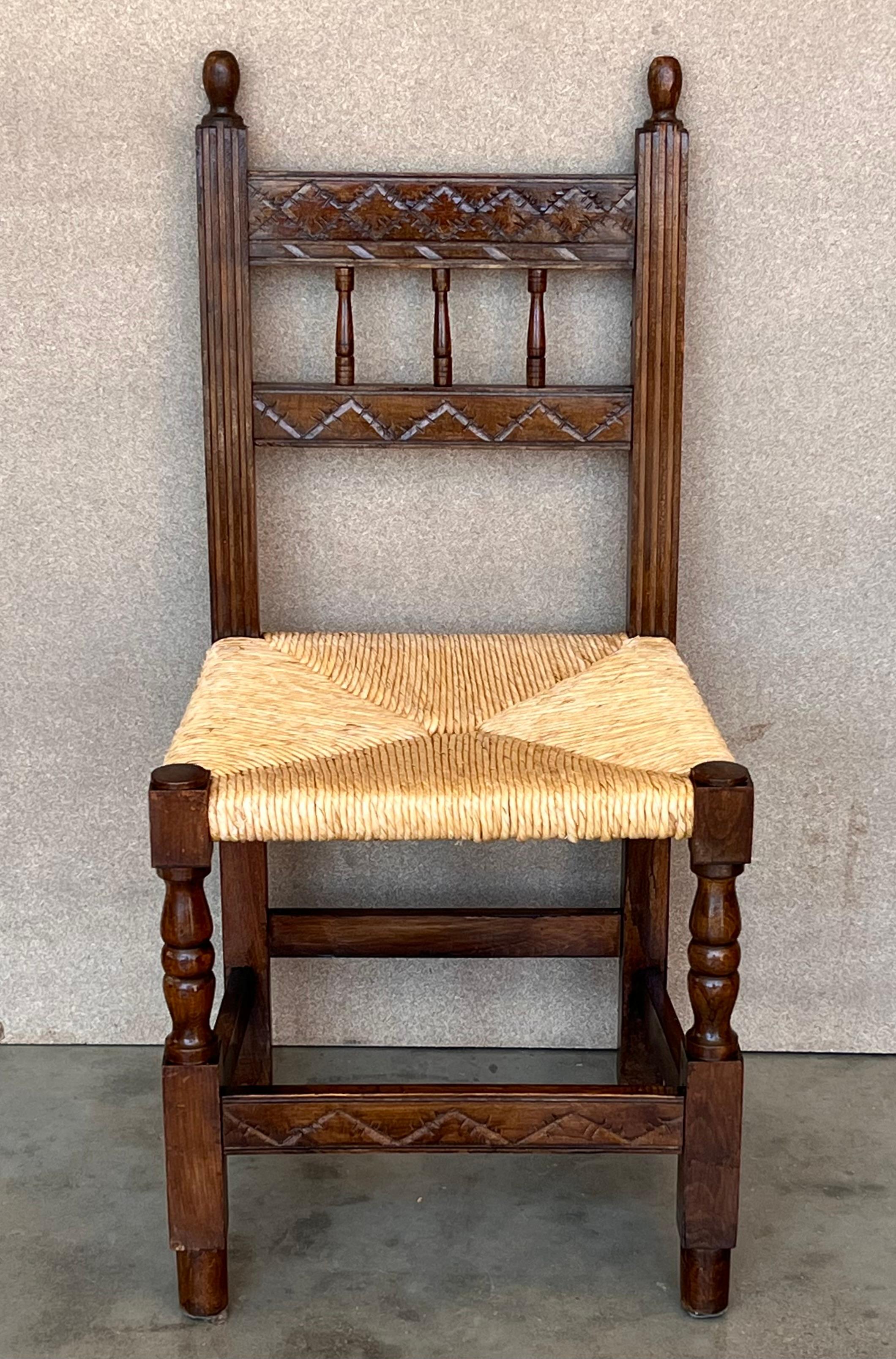 A set of 6 Spanish chairs with walnut structure with hand carved decoration. The seat are made of original cane. 
These chairs are true to the Spanish character and each features carvings that employ typical Spanish elements.

