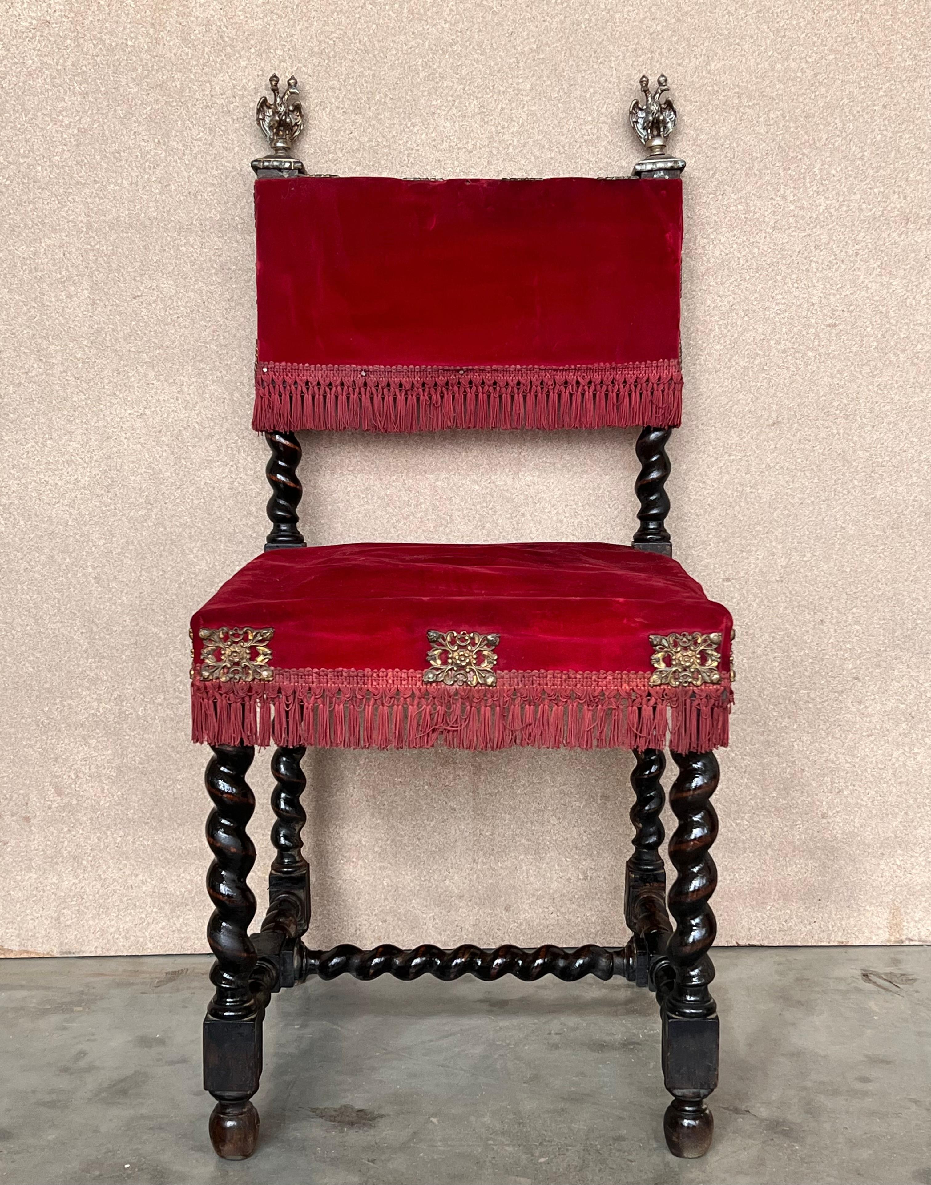 A set of 6 Spanish chairs with walnut structure, hand carved decoration and red velvet seat.
The pieces have a bronze details in the top.
These chairs are true to the Spanish character and each features carvings that employ typical Spanish