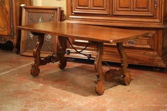 Early 20th Century Spanish Carved Walnut Trestle Table and Forged Iron Stretcher