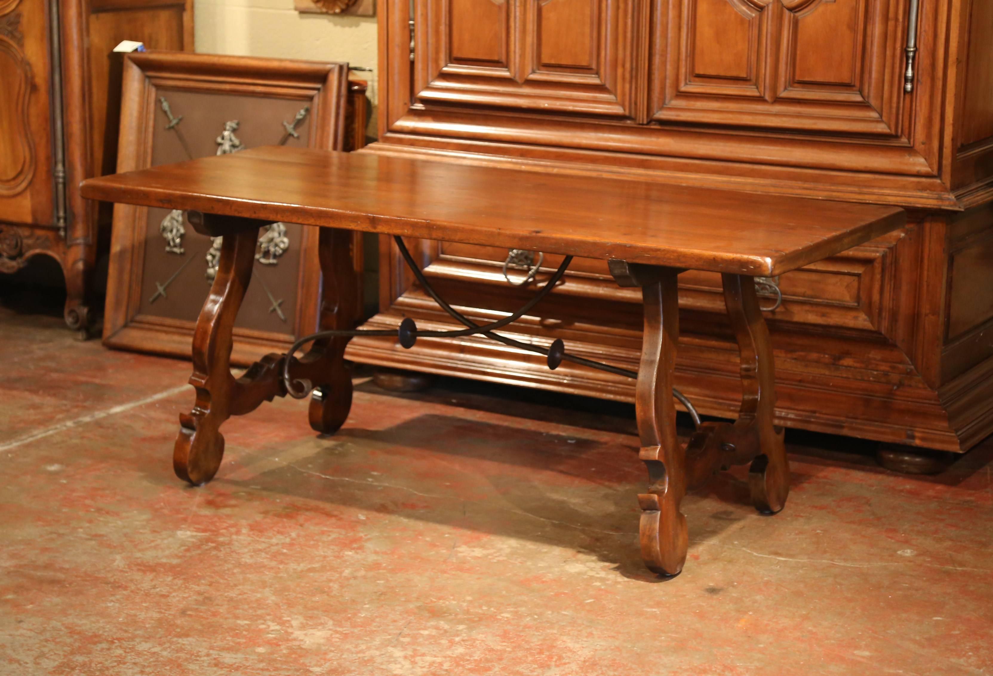 Early 20th Century Spanish Carved Walnut Trestle Table and Forged Iron Stretcher In Excellent Condition In Dallas, TX