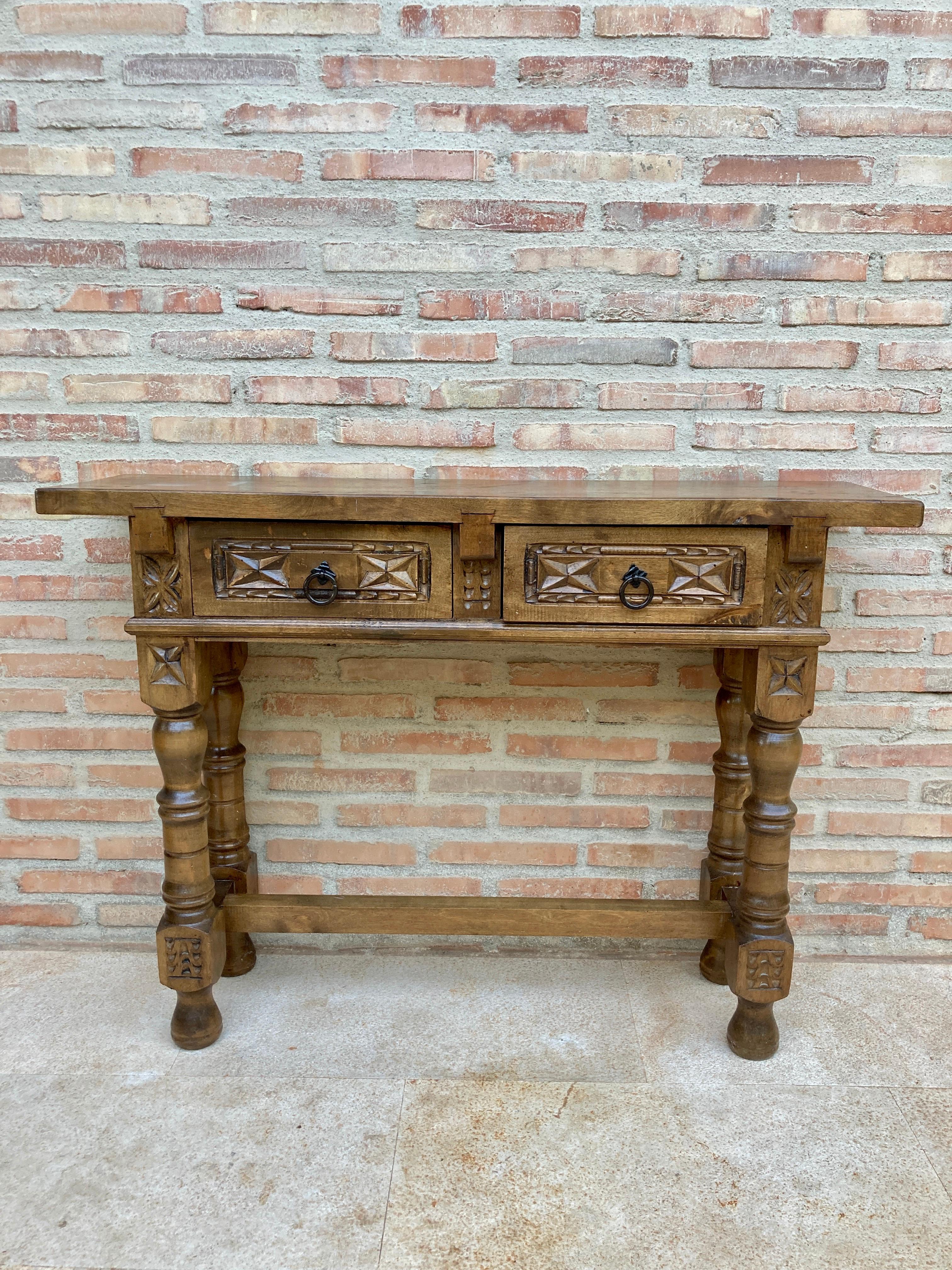 Vintage Design
This characterful table is of rare narrow depth of 11in. It is characteristic of Spanish Baroque furniture with a thick single piece top, simple bold chip carved ornament and bold turnings. It has a rich lustrous patina. The thick