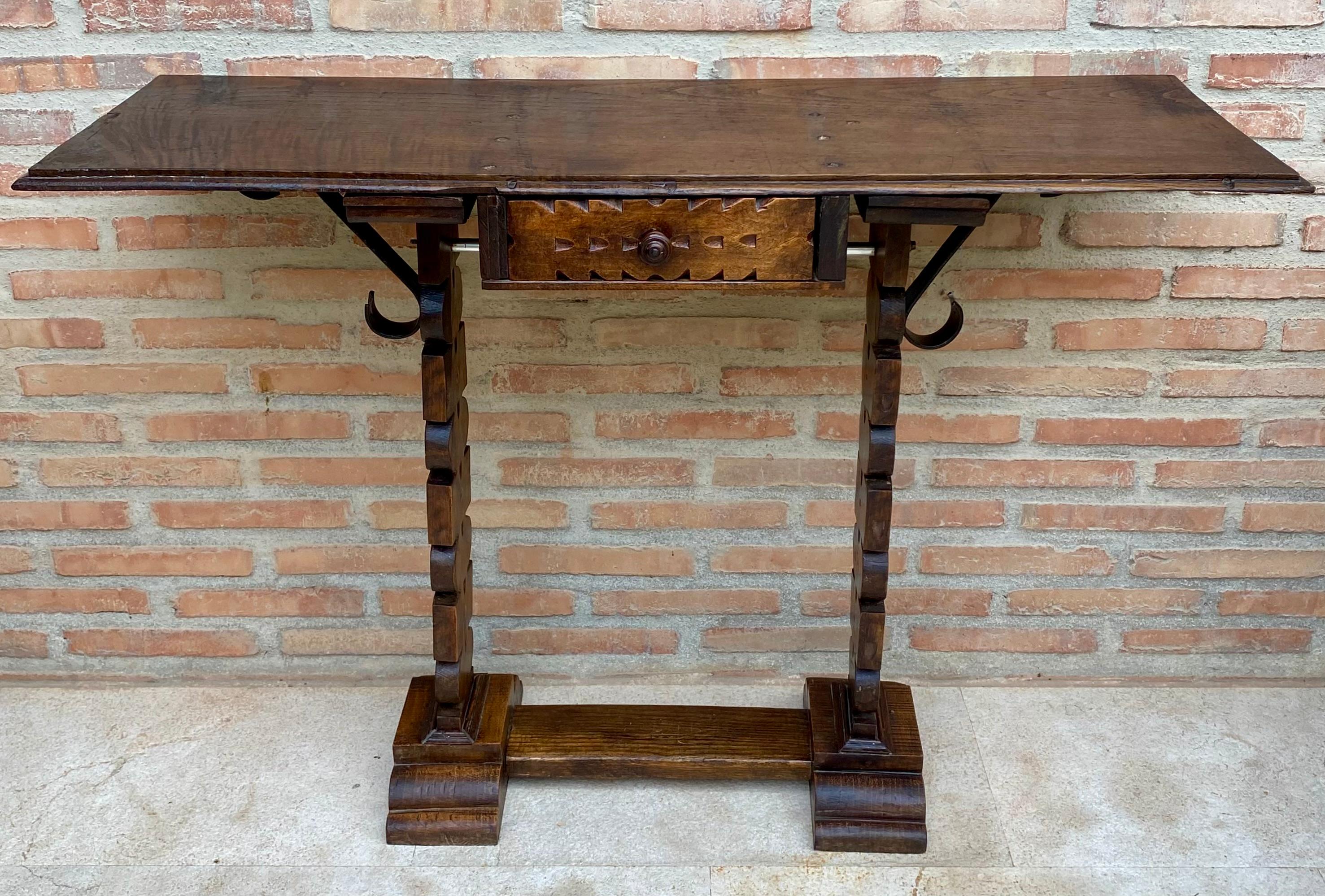 
Early 20th century Spanish Console Table with One Drawer. Early 20th Spanish console table with two pedestal legs joined by a carved bar stretcher.