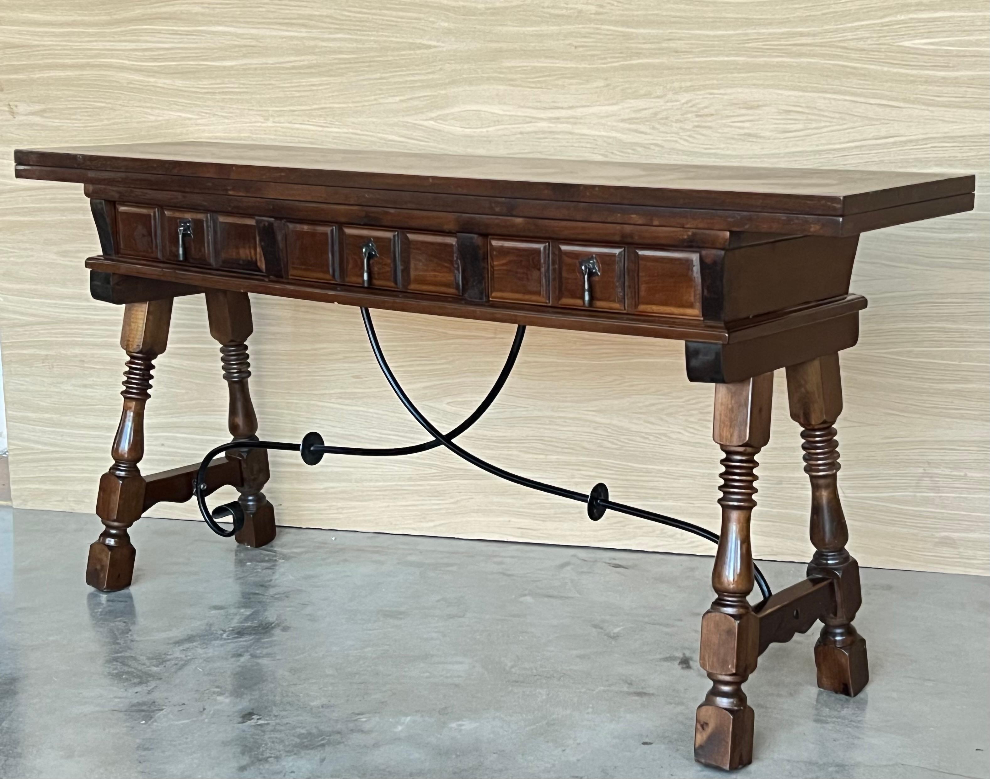Early 20th century Spanish console fold out table with iron stretcher & three drawers.
A beautiful early 20th century Spanish console fold out farm table.
Works as both a dining table and console.
This Console is perfect to decorate our entrance to