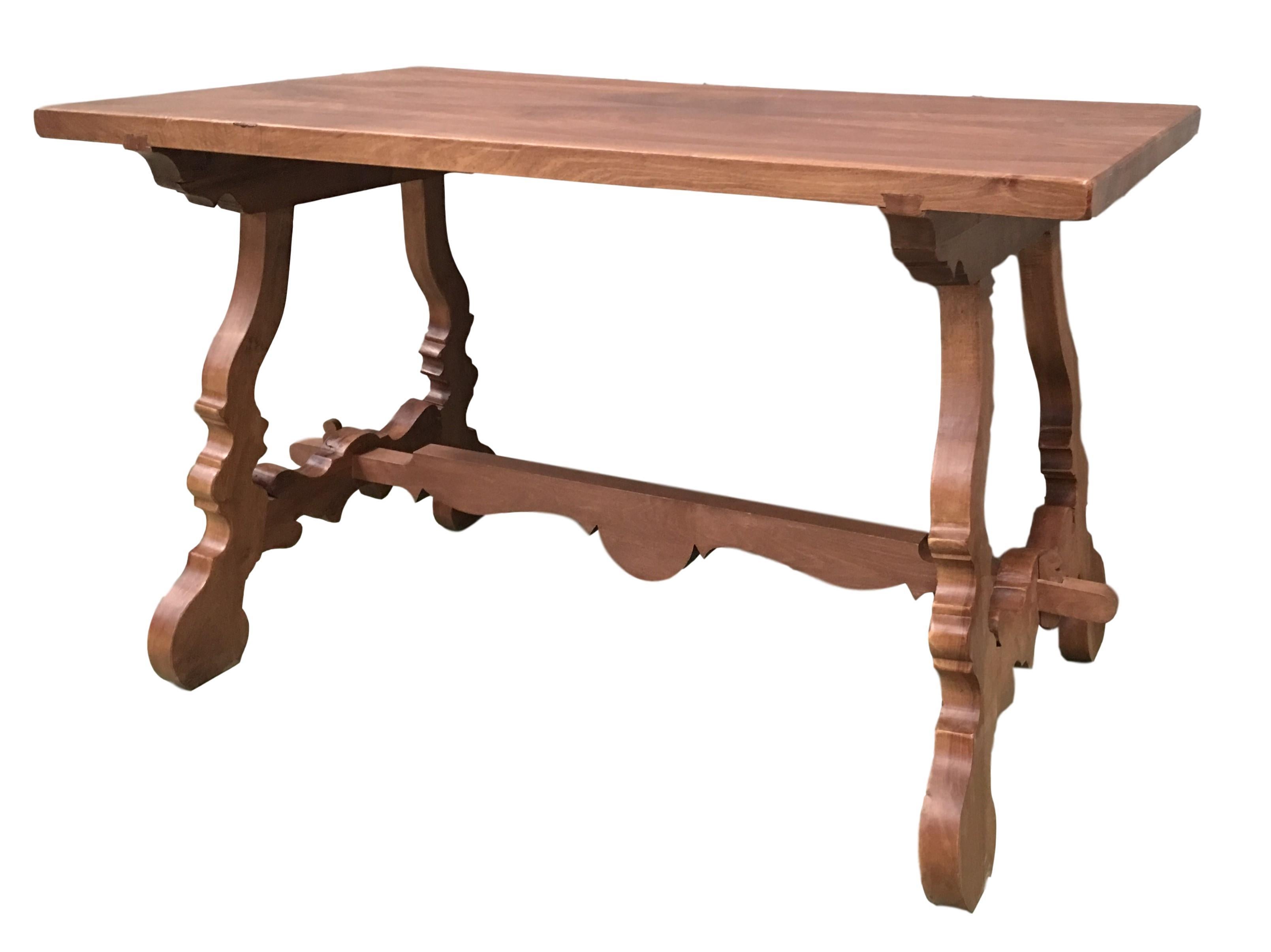 Early 20th century Spanish pine trestle table with wood stretcher.