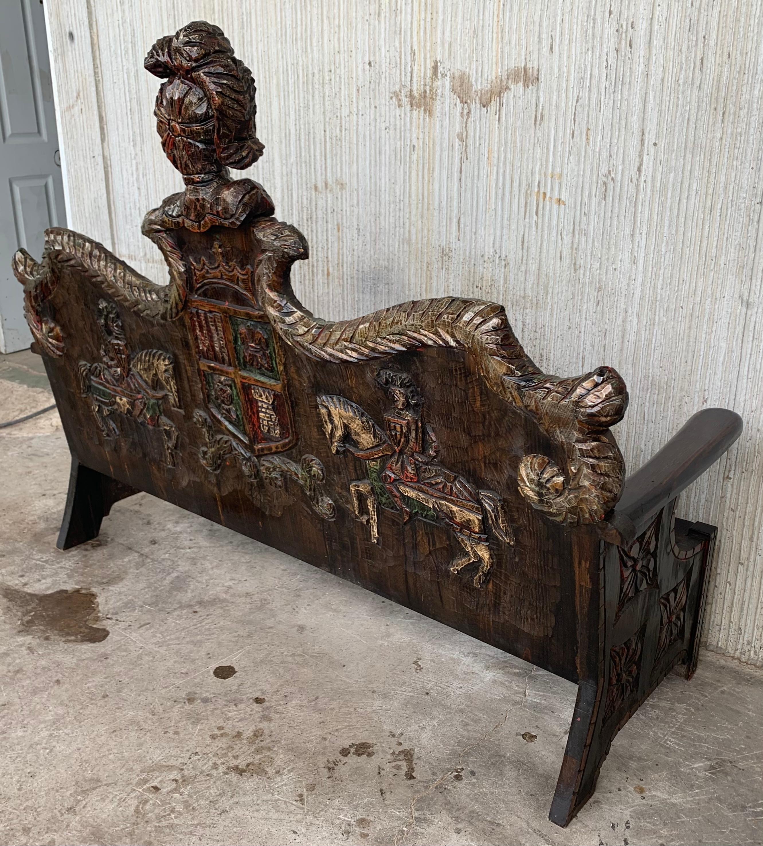 Early 20th century Spanish bench made from oak. The back is exquisitely hand carved with two differents motifs, surrounded by decorative carvings. The sides and back are made up of matching decorative pierced carvings. The seat has a beveled front