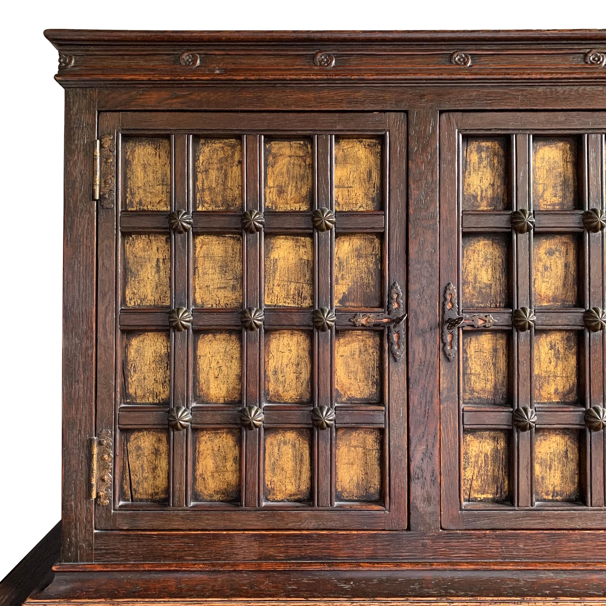 British Early 20th Century Tudor Revival Cabinet with Gold Leaf Paneled Doors