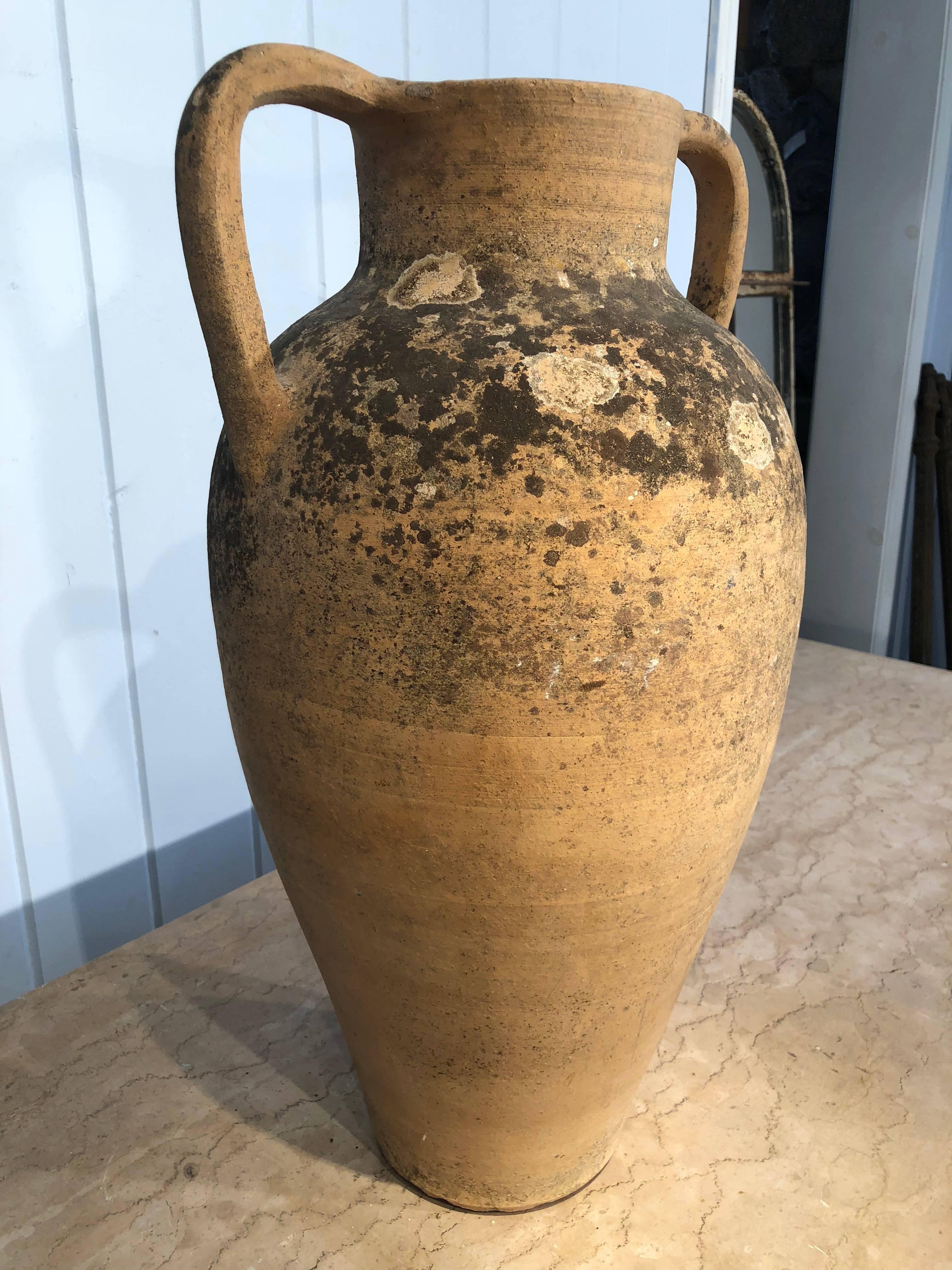 This stunning double-handled Amphora was originally used for water and is in perfect condition. With its beautiful patina, it would make a lovely planter inside or out, or use it simply as an objet d'art. It already has a drain hole drilled, but